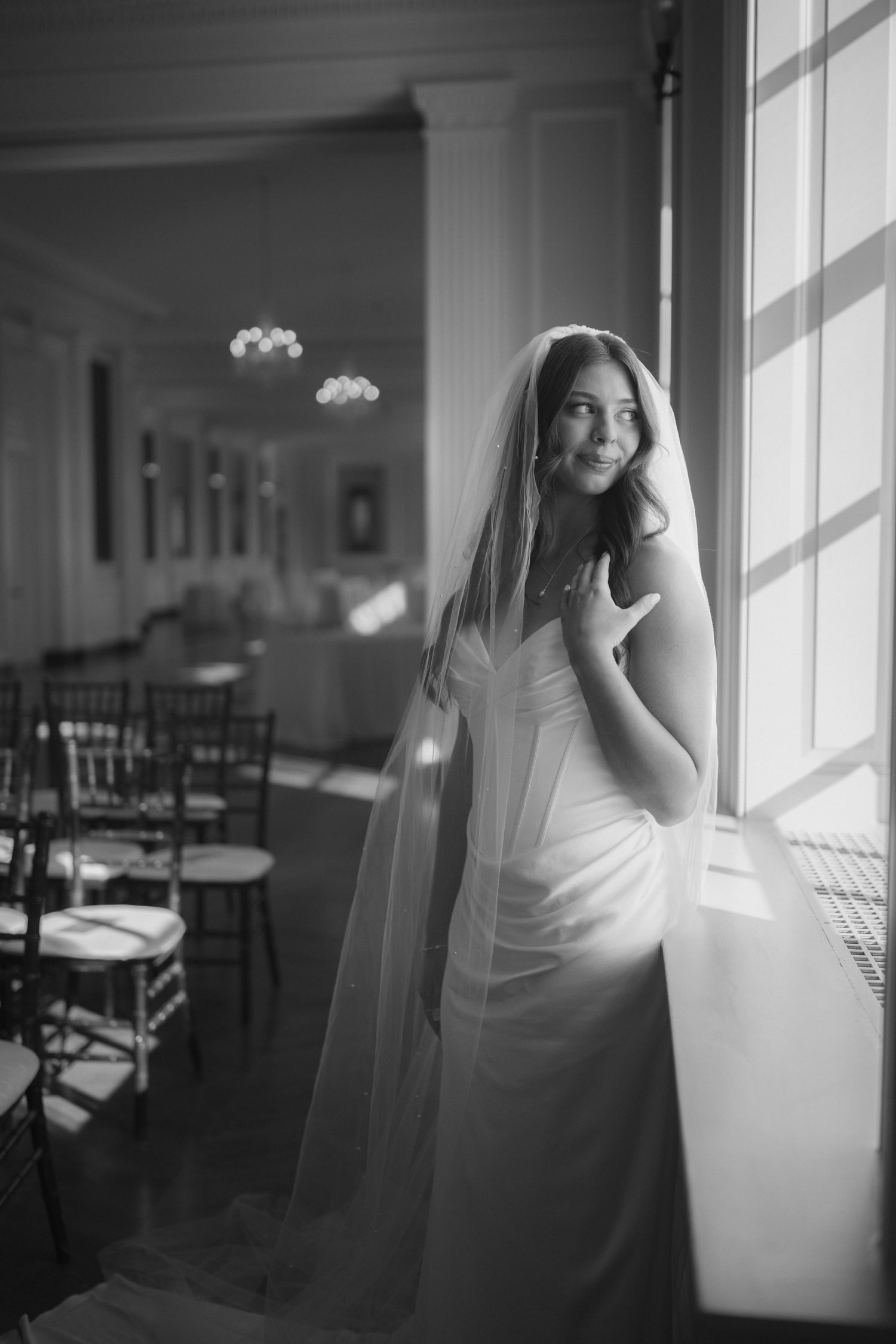 Black and white portrait sequence showing movement near bright sunlit windows.