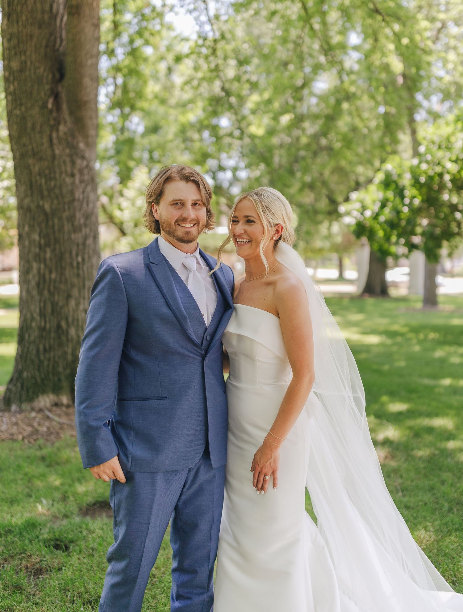 Couple shares romantic moments in a garden setting during their wedding.