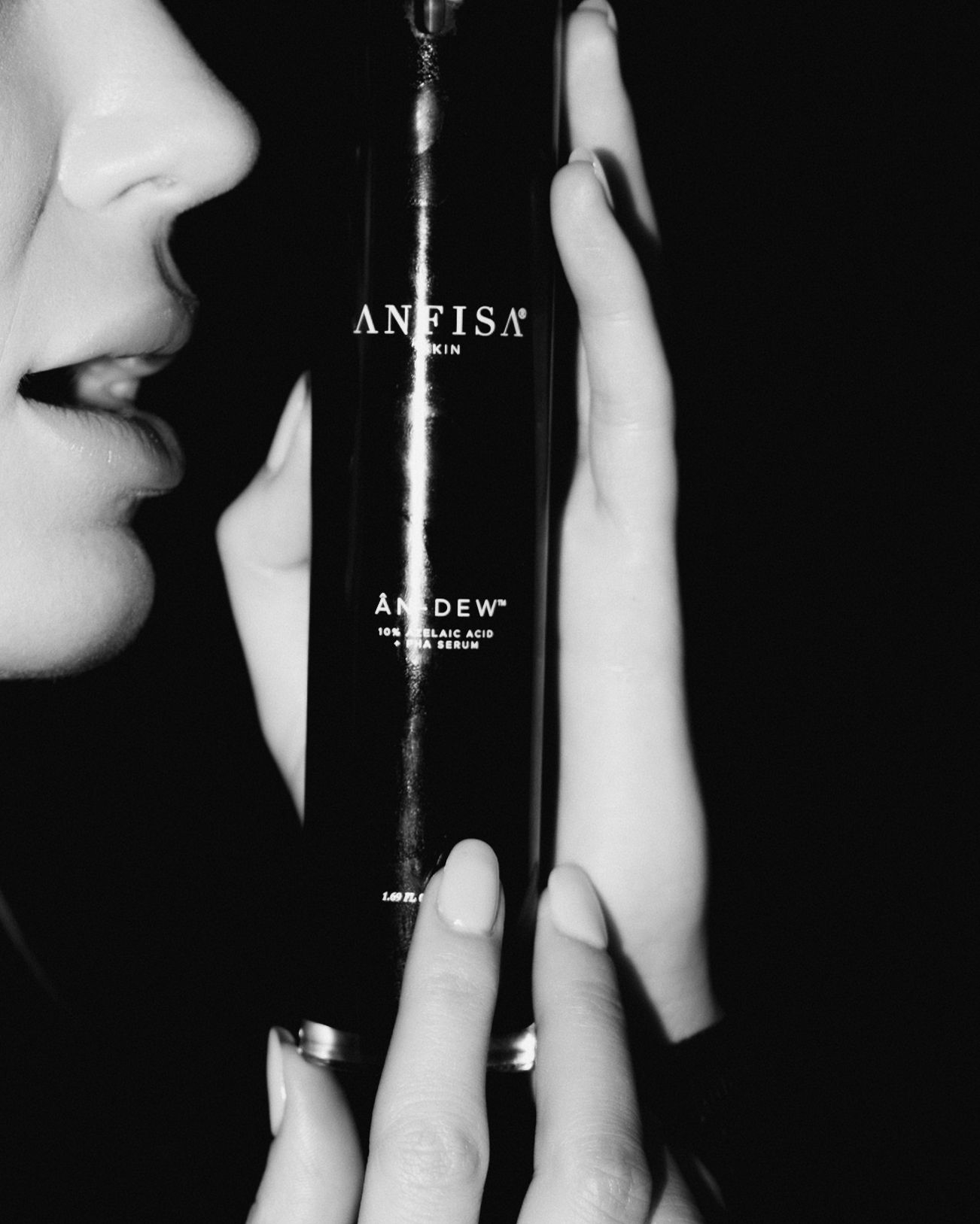 Black and white artistic photograph showing hands and shadows against a stark contrasting background.