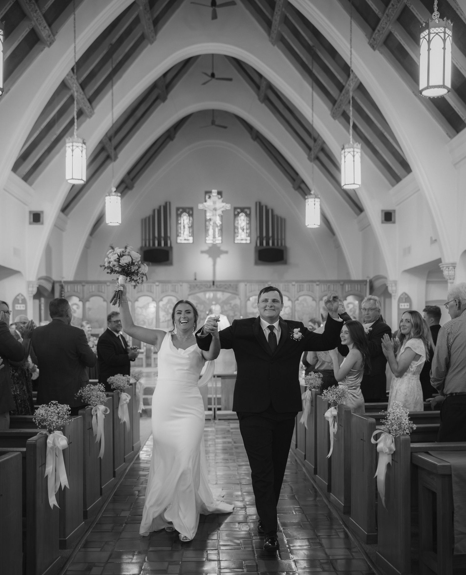 Black and white wedding photos showing a bride and escort walking down the aisle in a traditional church ceremony.