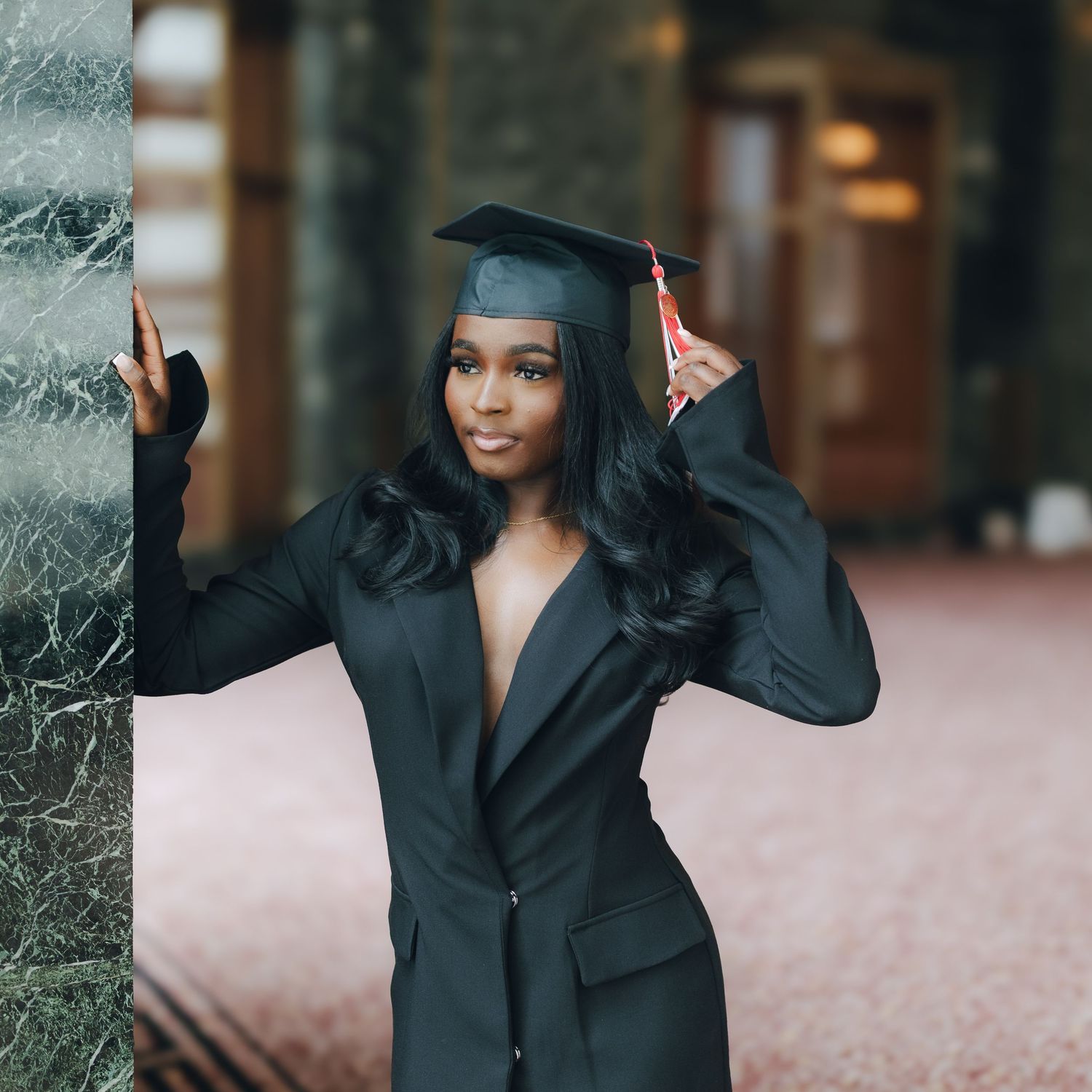Professional portrait session featuring a person in a black blazer and hat posing outdoors with a natural smile.