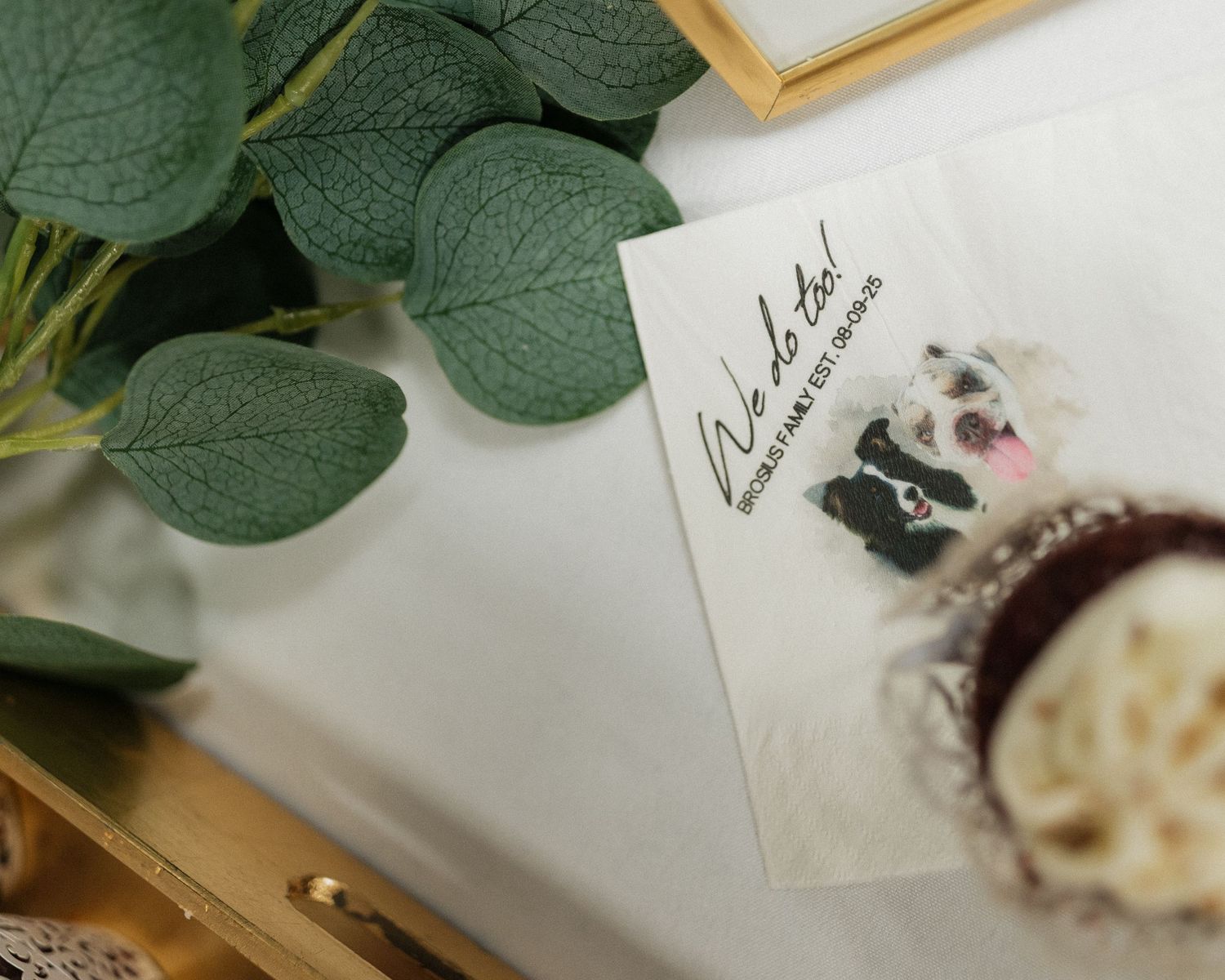 Wedding invitation details with eucalyptus leaves and elegant stationery.