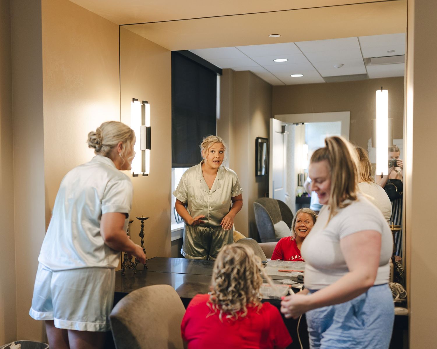 Healthcare workers assist elderly residents in a nursing home hallway with daily activities and care.