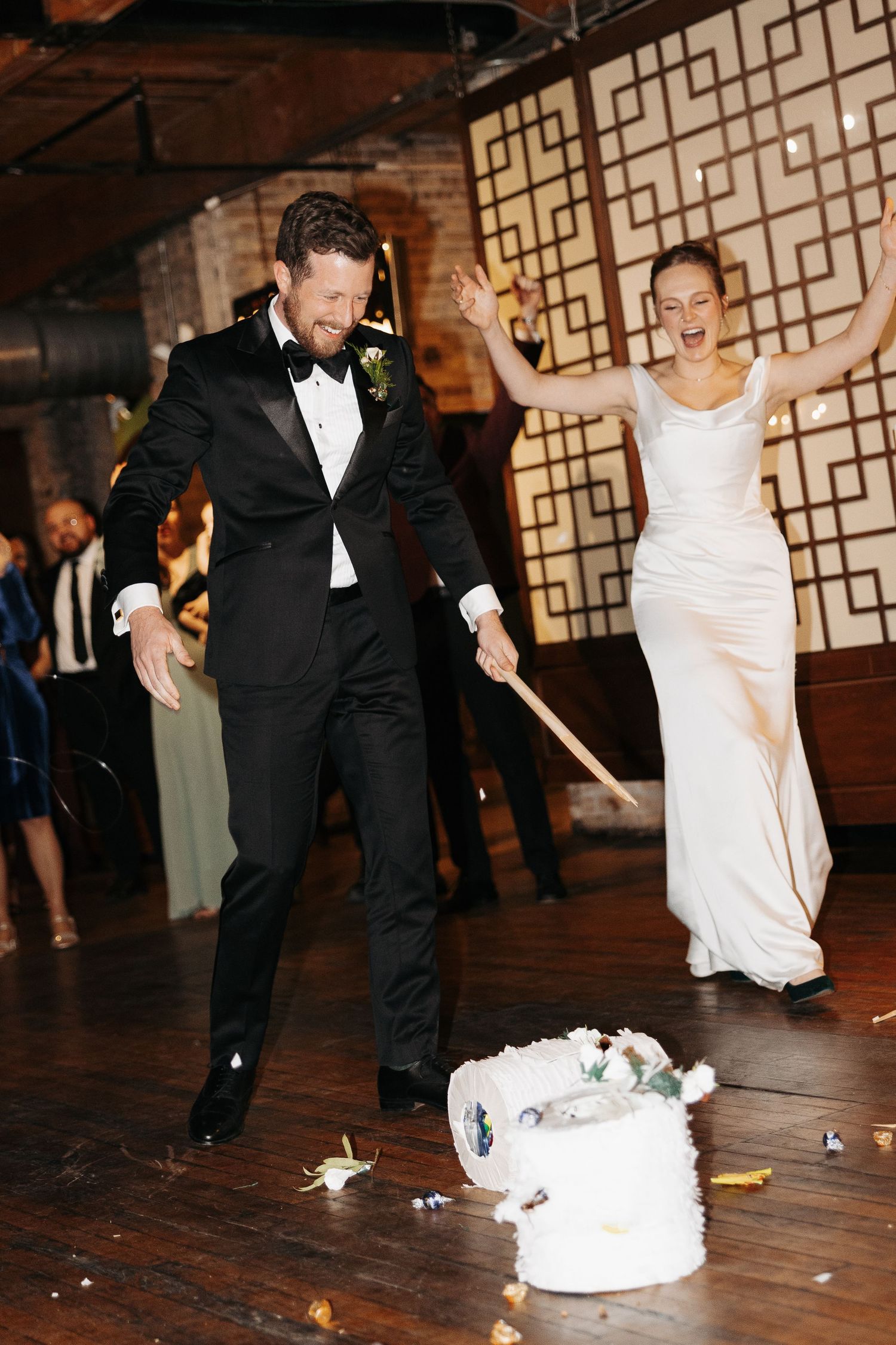 Wedding guests participate in a traditional dollar dance where money is thrown on the dance floor during reception celebrations.