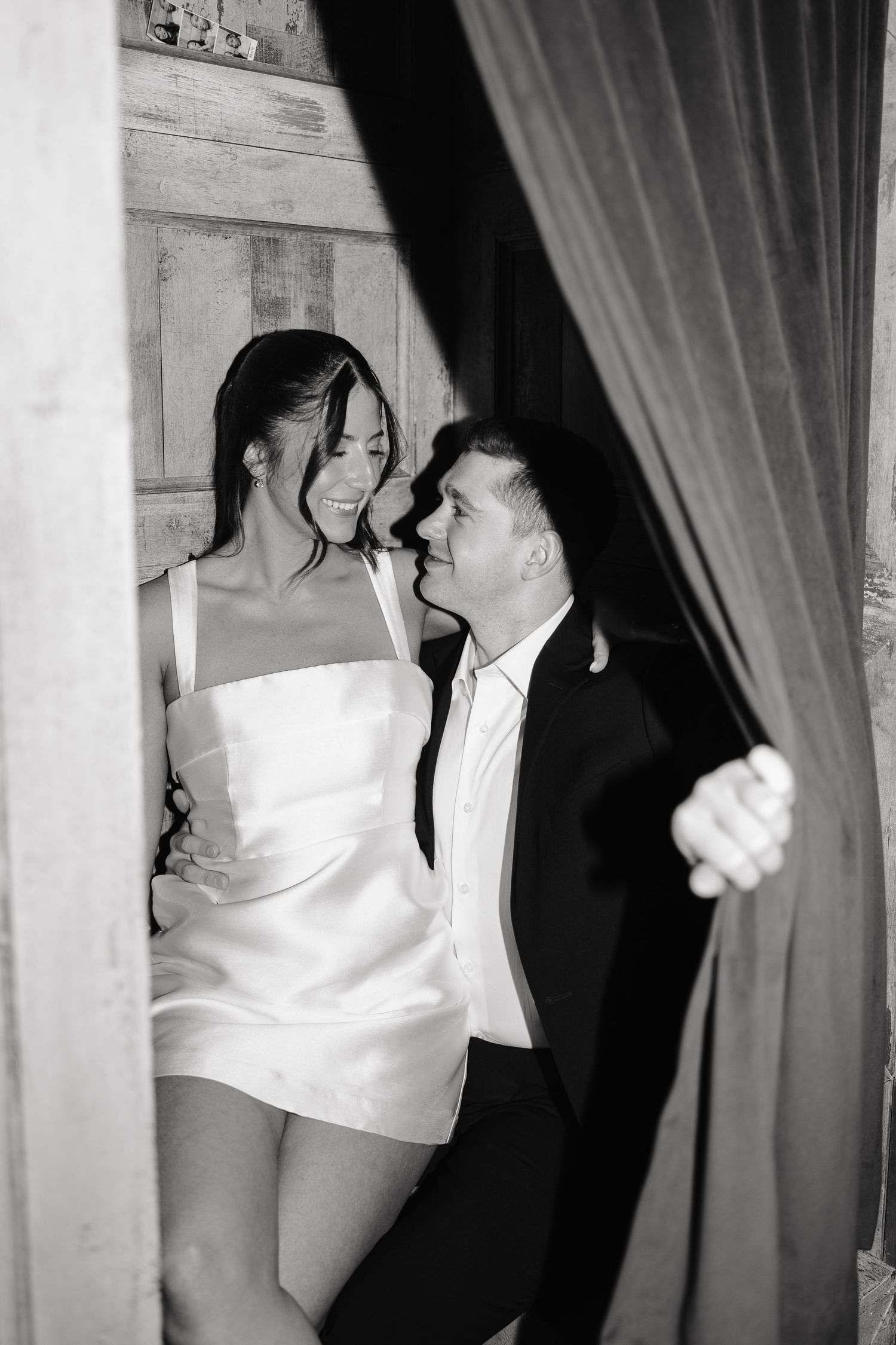 A black and white photo strip showing four sequential frames of a couple dancing and embracing at what appears to be a party.