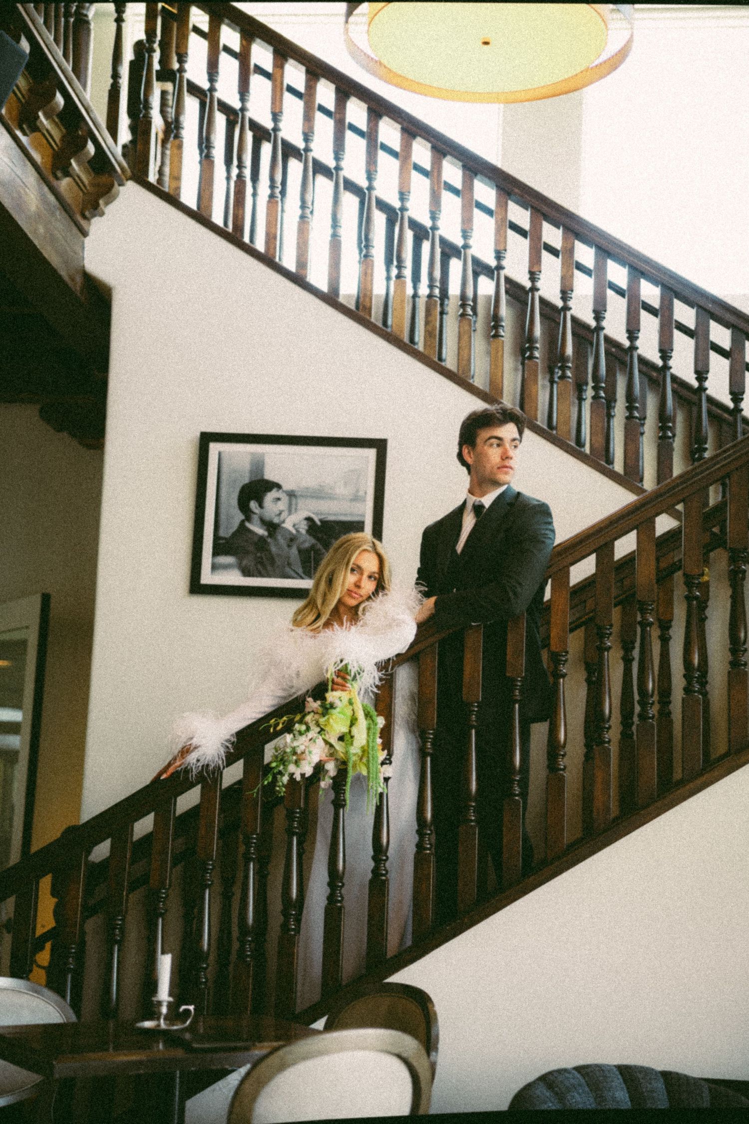 Four film photos show a couple posing on a staircase in a romantic wedding photoshoot.