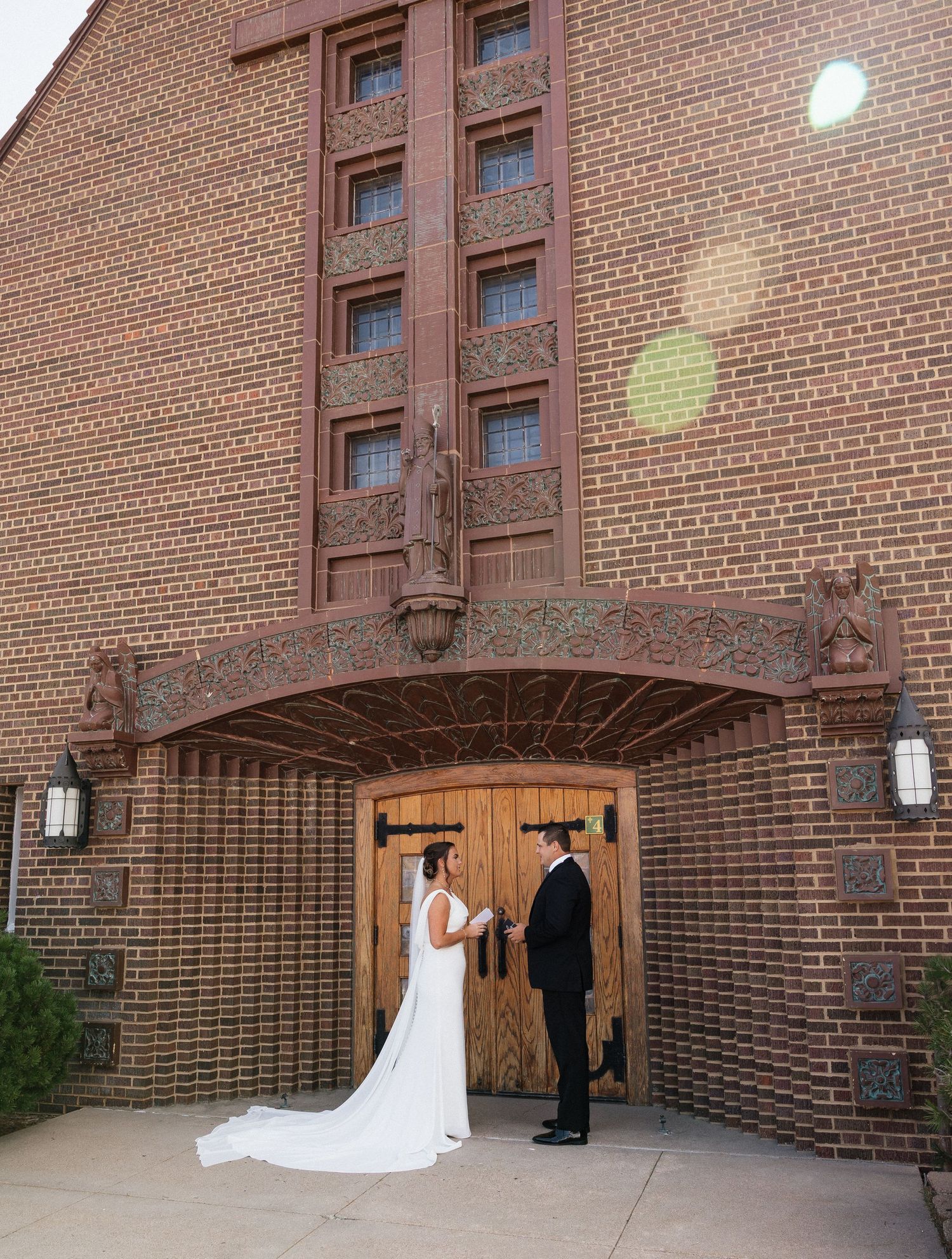 Elegant wedding photo sequence captured against rustic brick church exterior.
