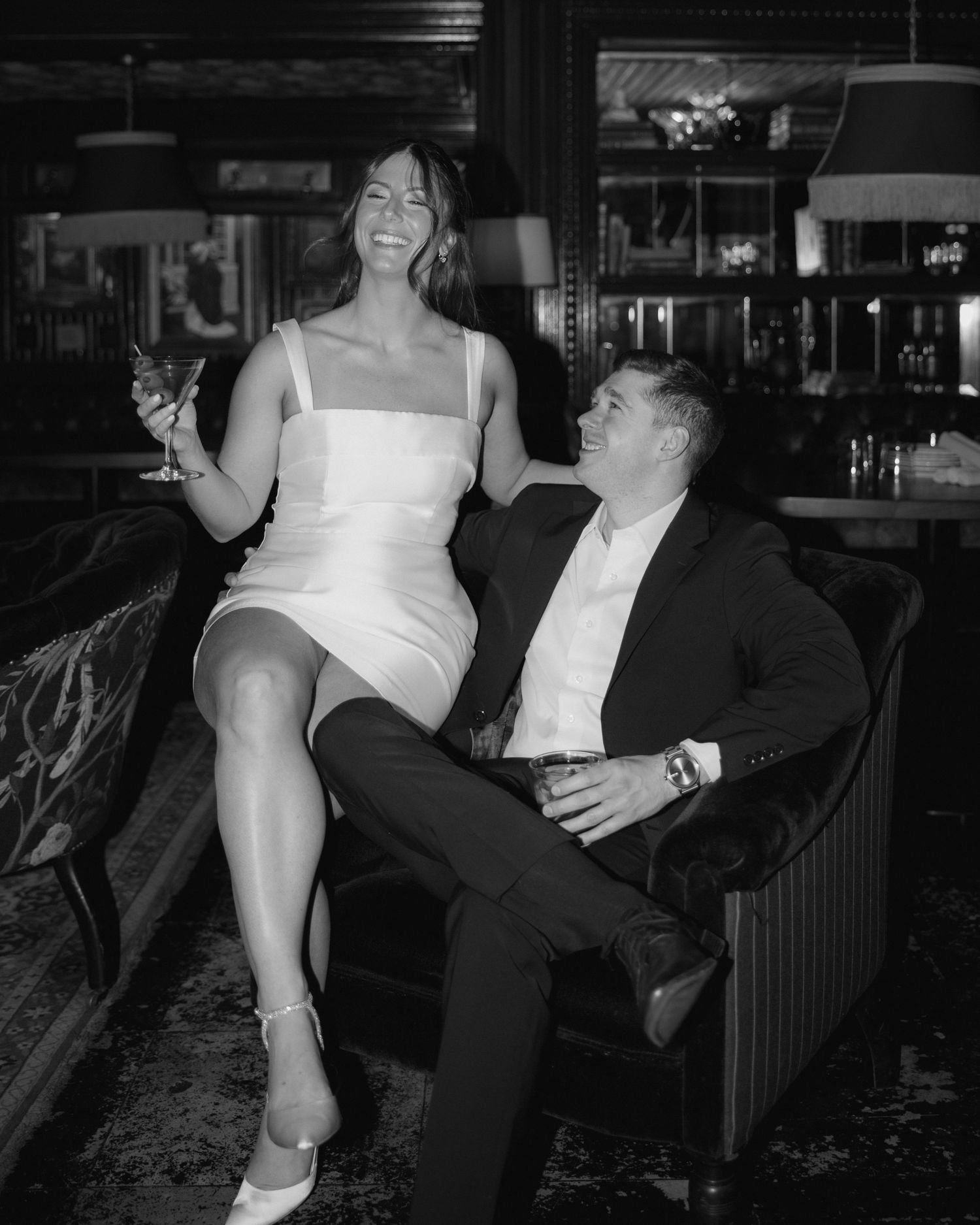 A black and white photo series shows a couple laughing and dancing together at what appears to be a bar or party venue.