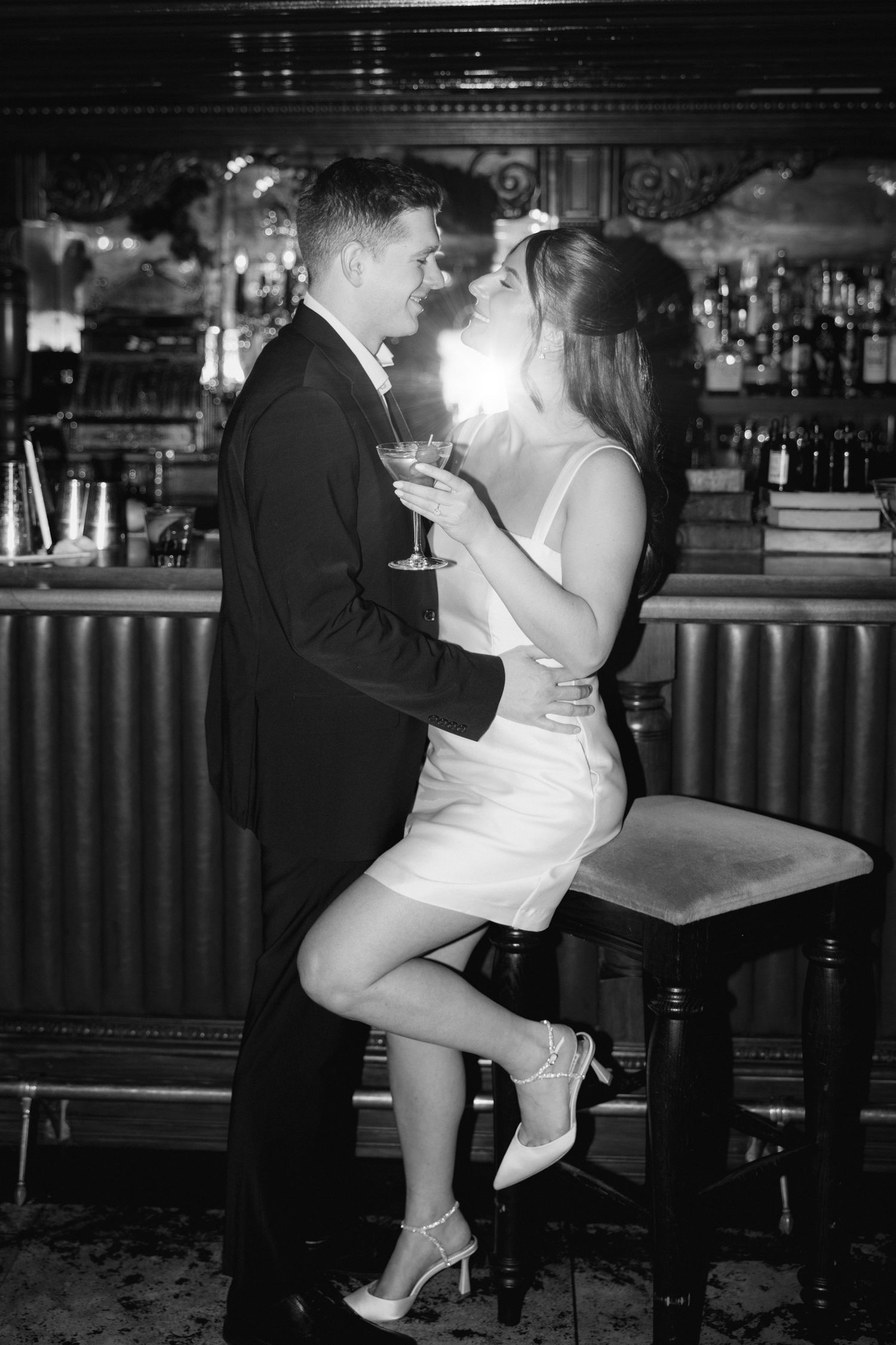 A romantic black and white photo sequence shows a couple dancing intimately at a bar counter.