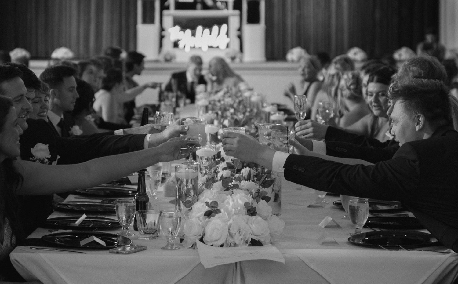 Black and white view of elegant table settings at a wedding reception.