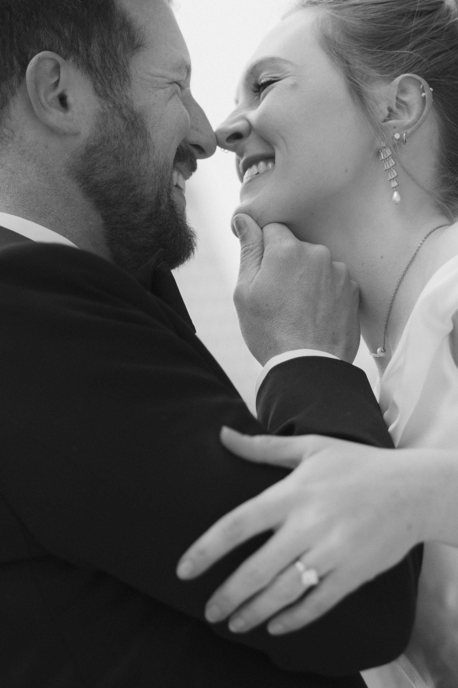 A romantic sequence of black and white wedding photos showing tender kisses and embraces between newlyweds.