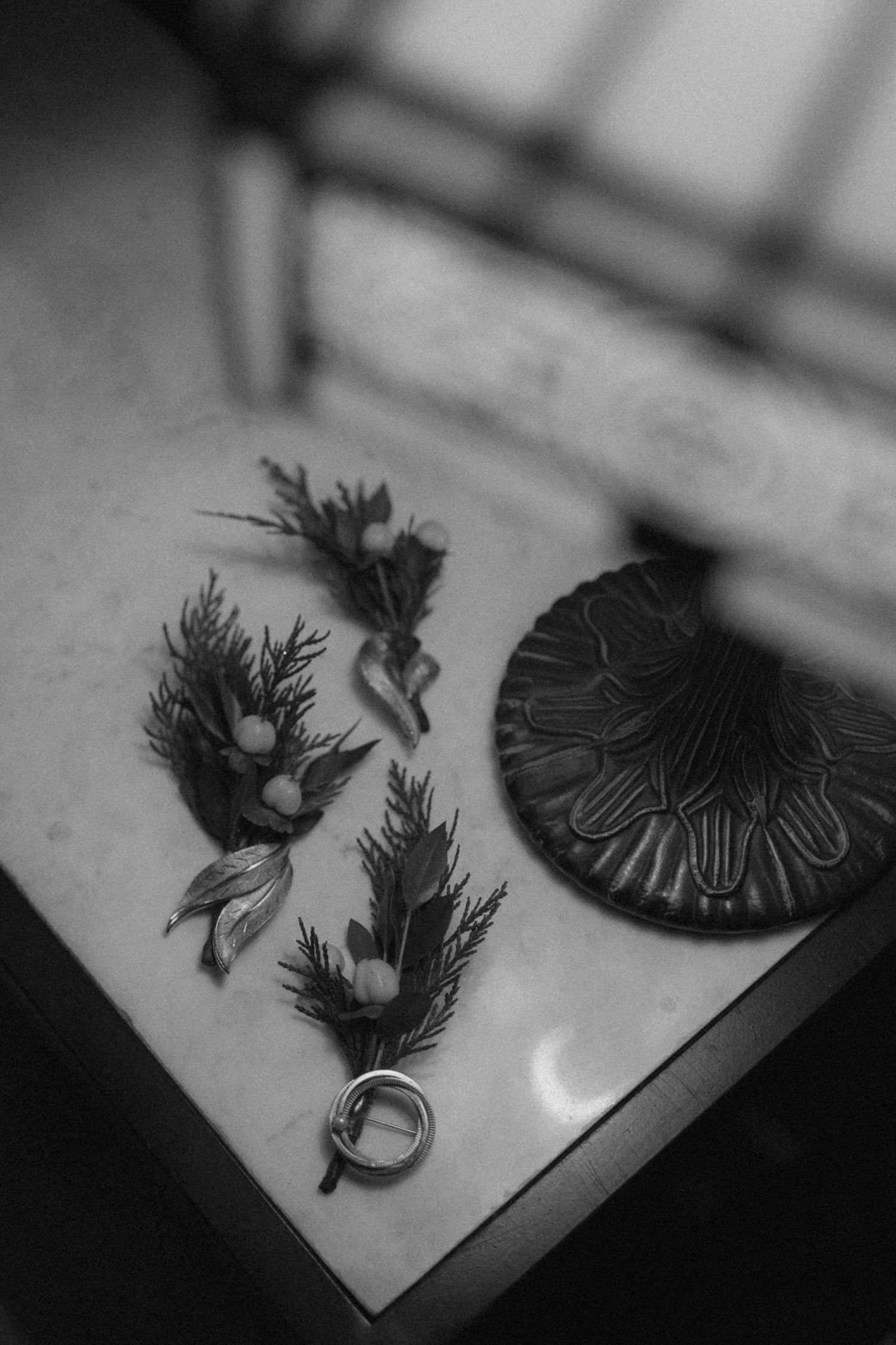A sequence of black and white images showing a pop-up paper craft animation with feather-like shapes in motion.