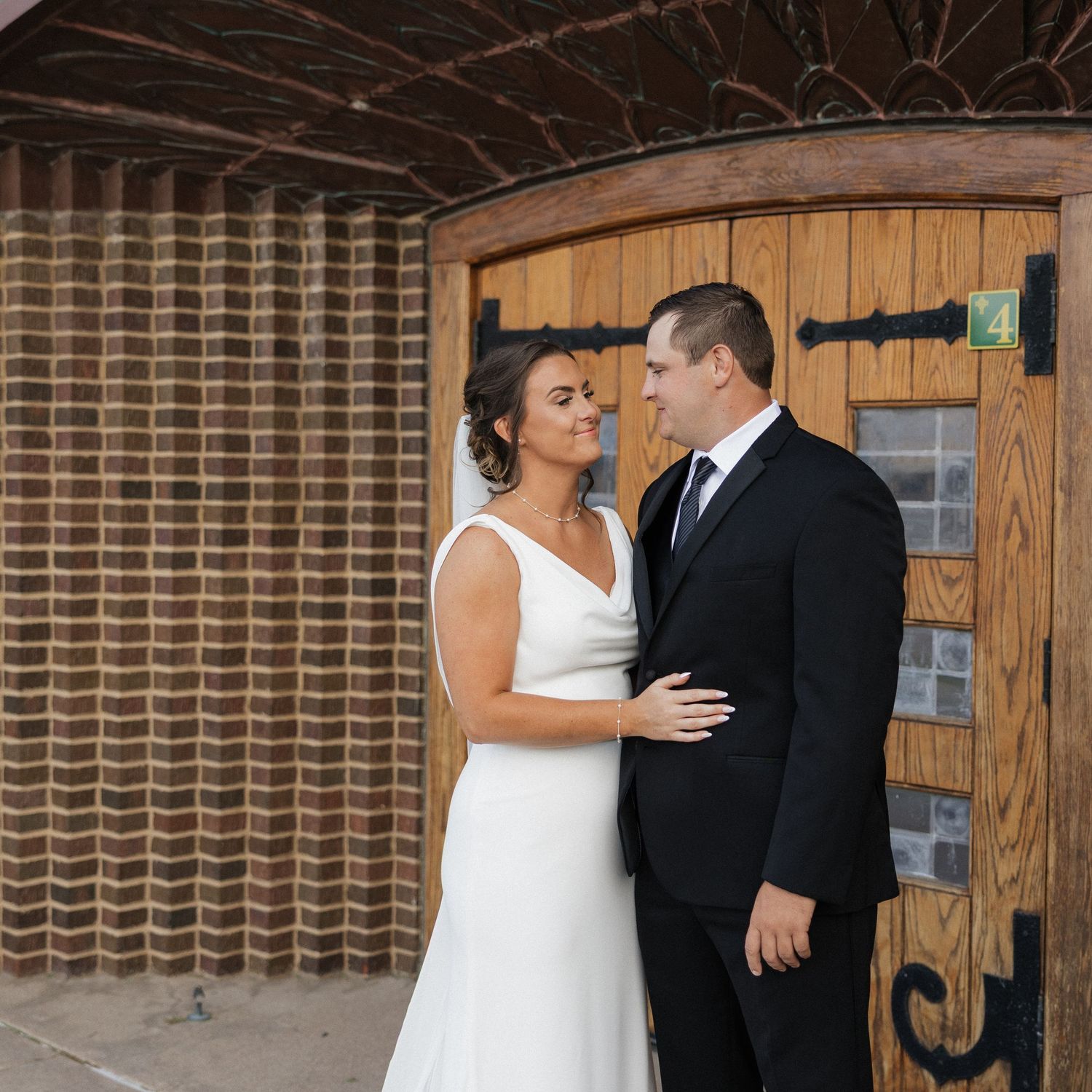 A romantic wedding photo sequence showing a couple in white dress and black suit against a brick wall.