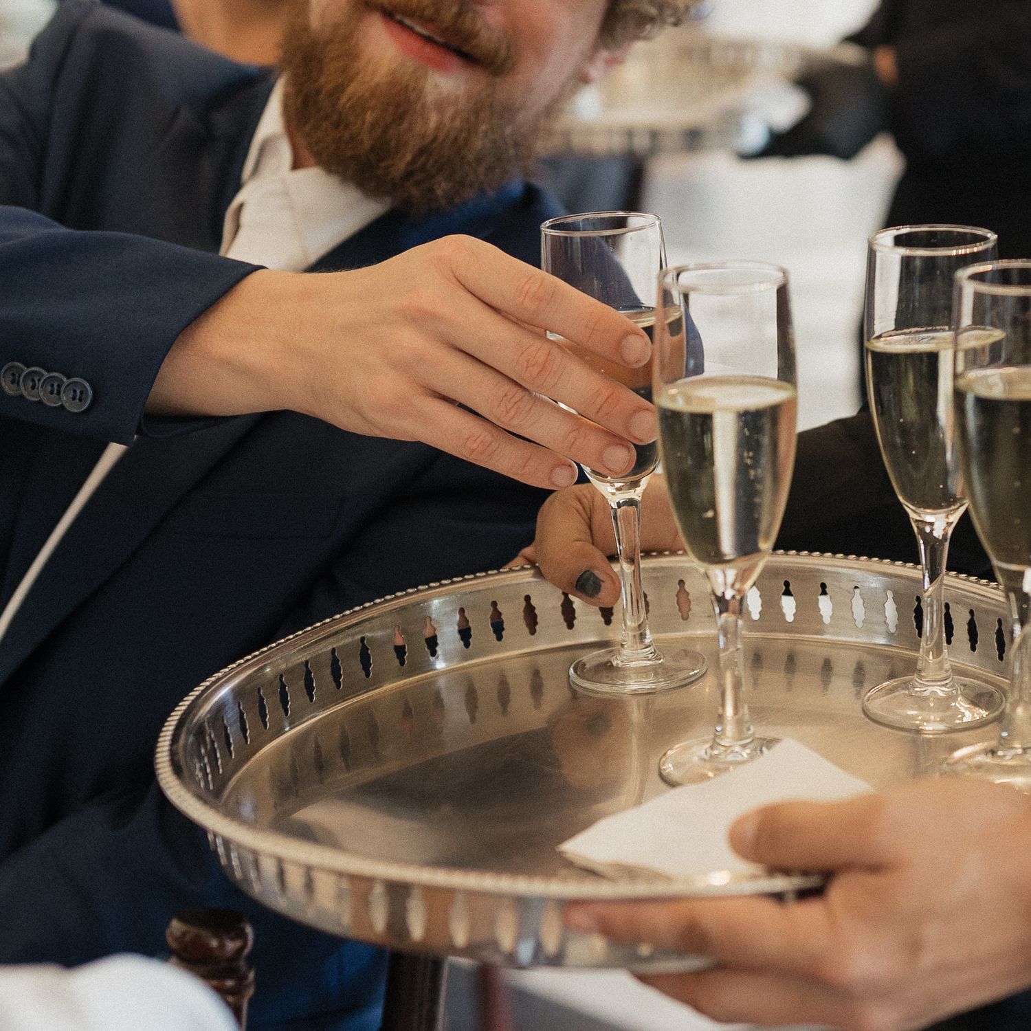 Champagne glasses and table settings at an elegant wedding reception.