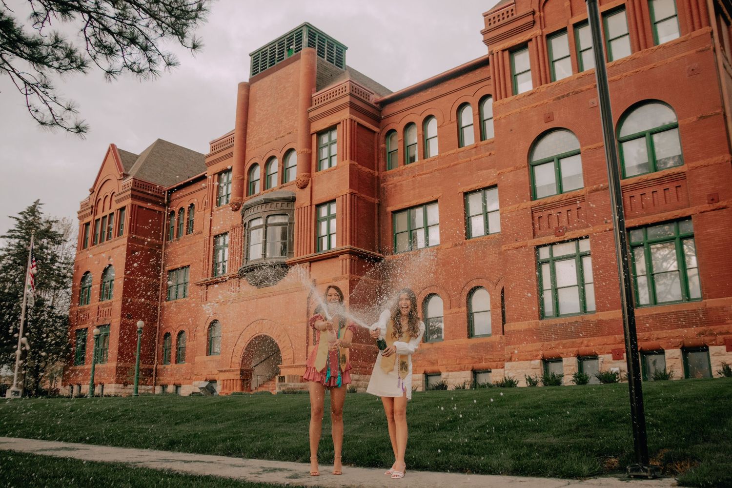 Historic red brick school building with arched windows and Victorian architecture photographed from multiple angles.