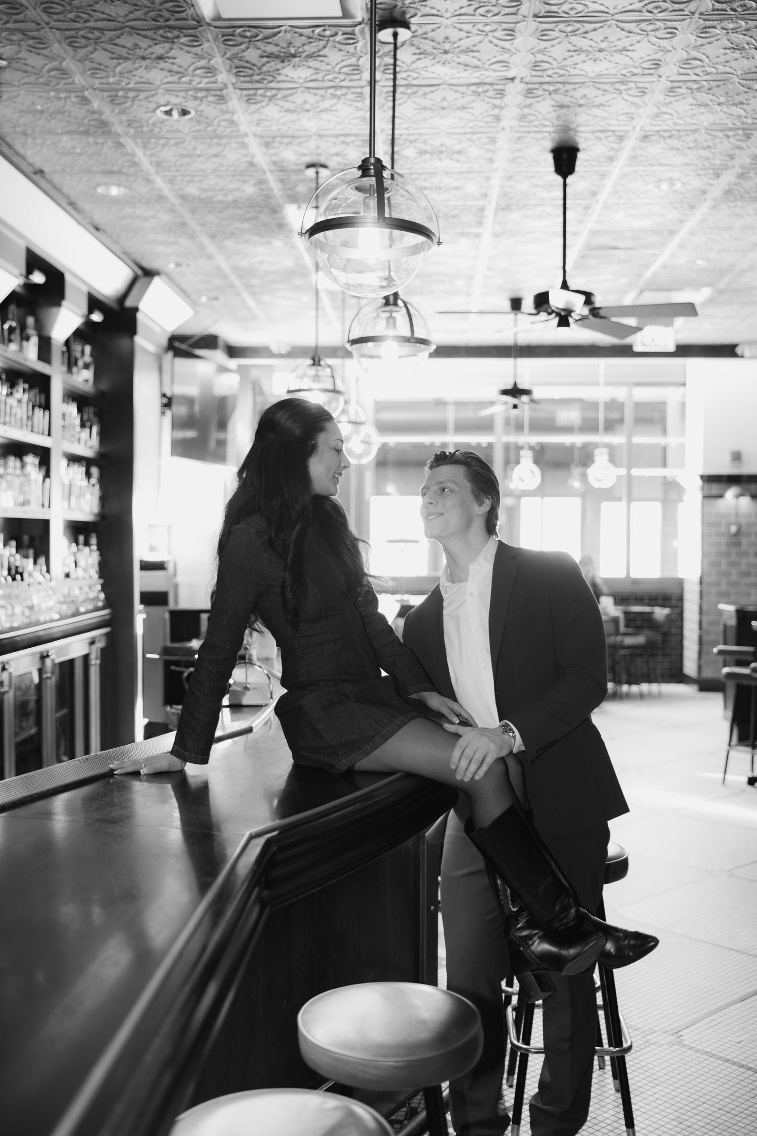 A series of black and white photos showing silhouettes of people at a bar counter in an empty establishment.