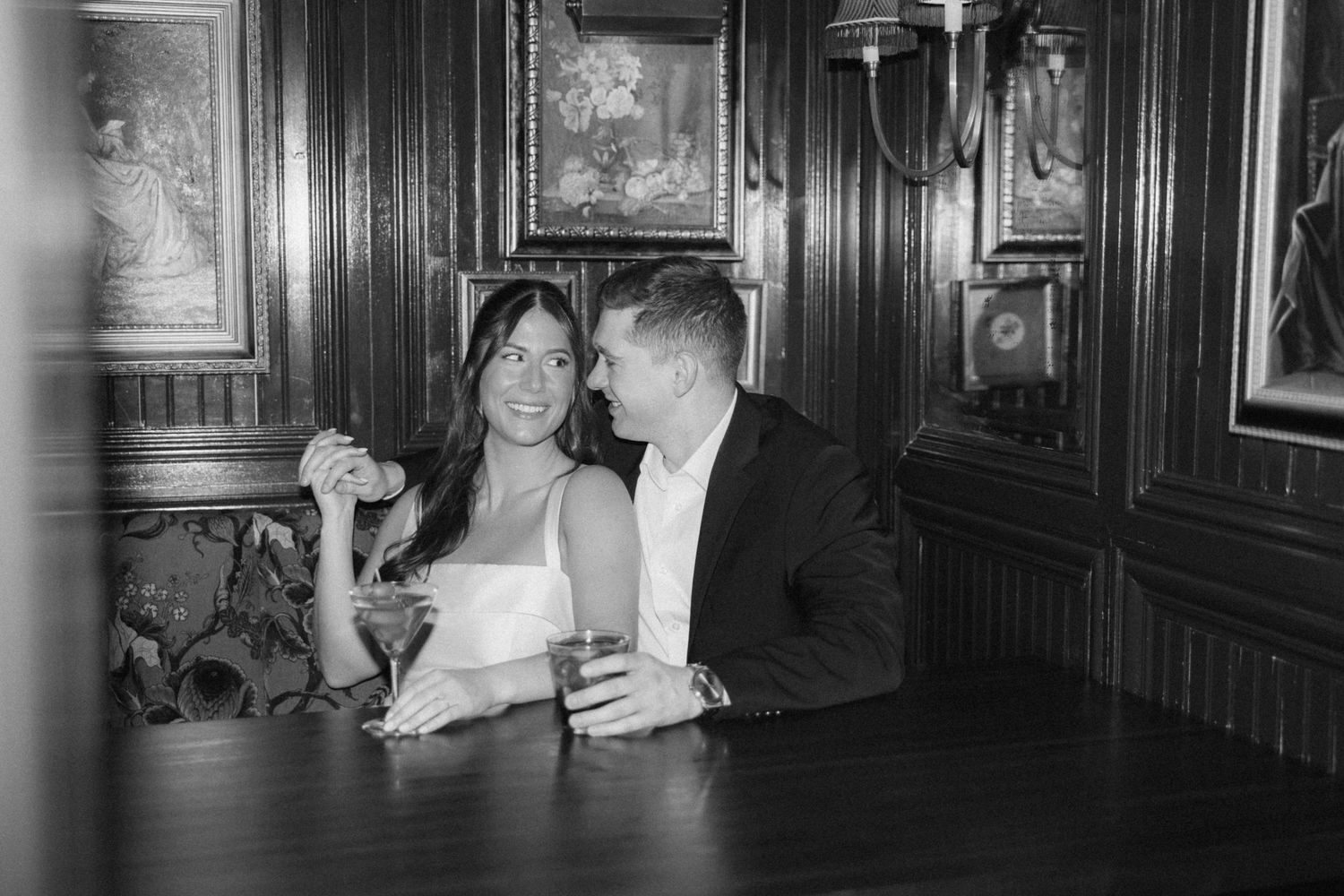 A black and white photo series showing a couple in formal attire dancing together in an elegant wood-paneled room.