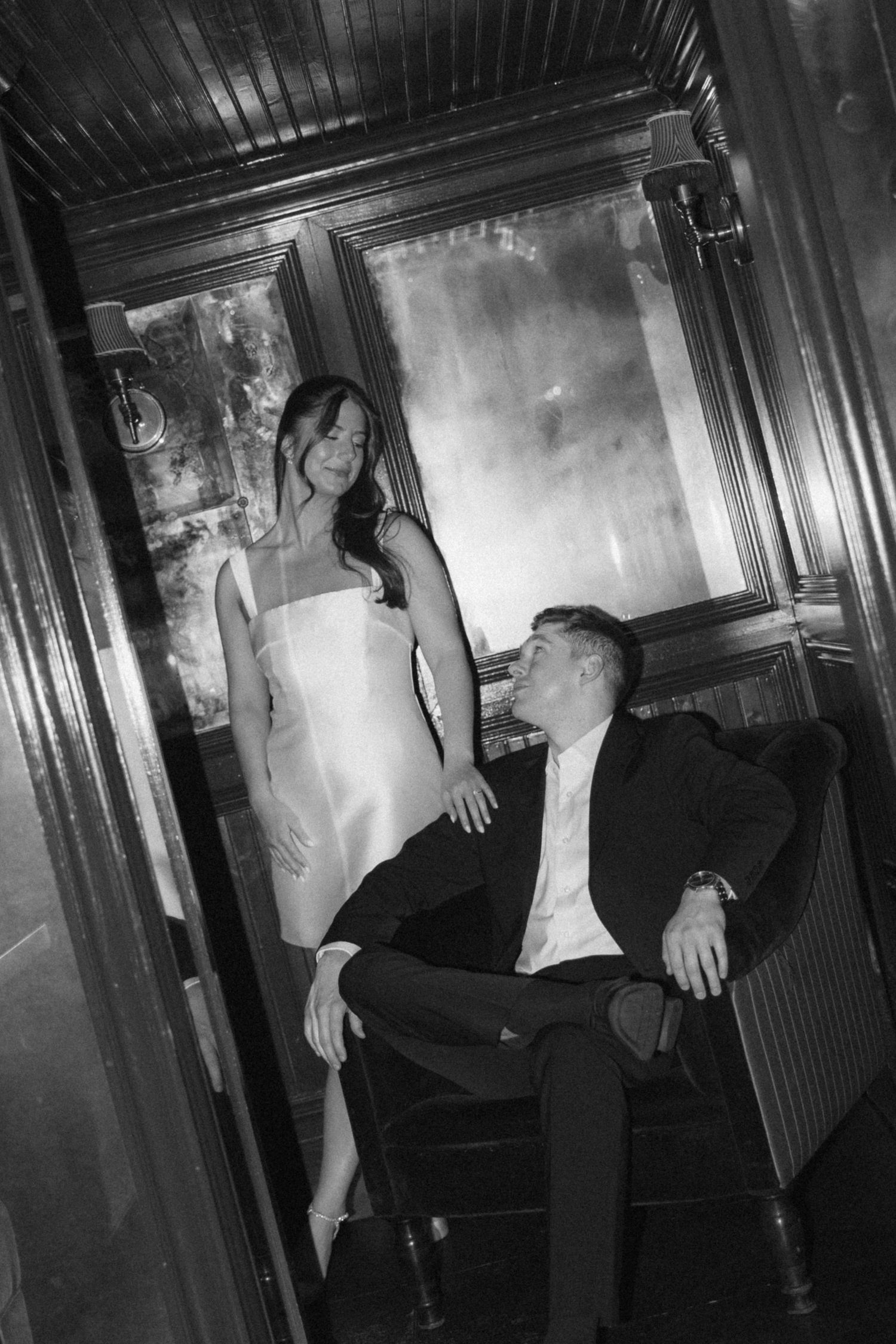 Black and white photo series showing people dancing in a dimly lit corridor or hallway space.