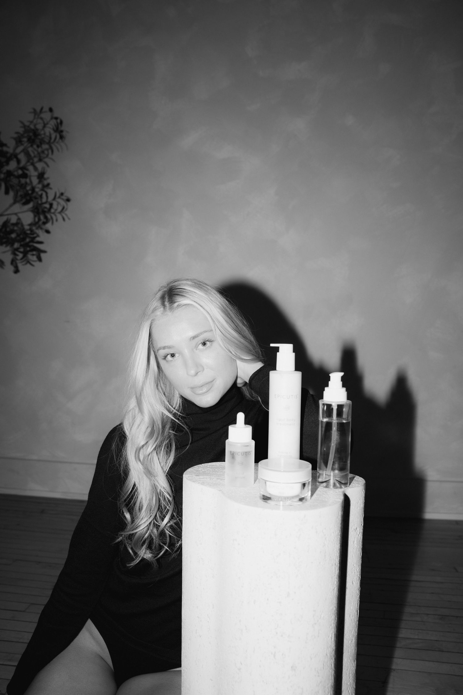 A black and white artistic photo series showing a person in dark clothing next to white candles creating dramatic shadows.