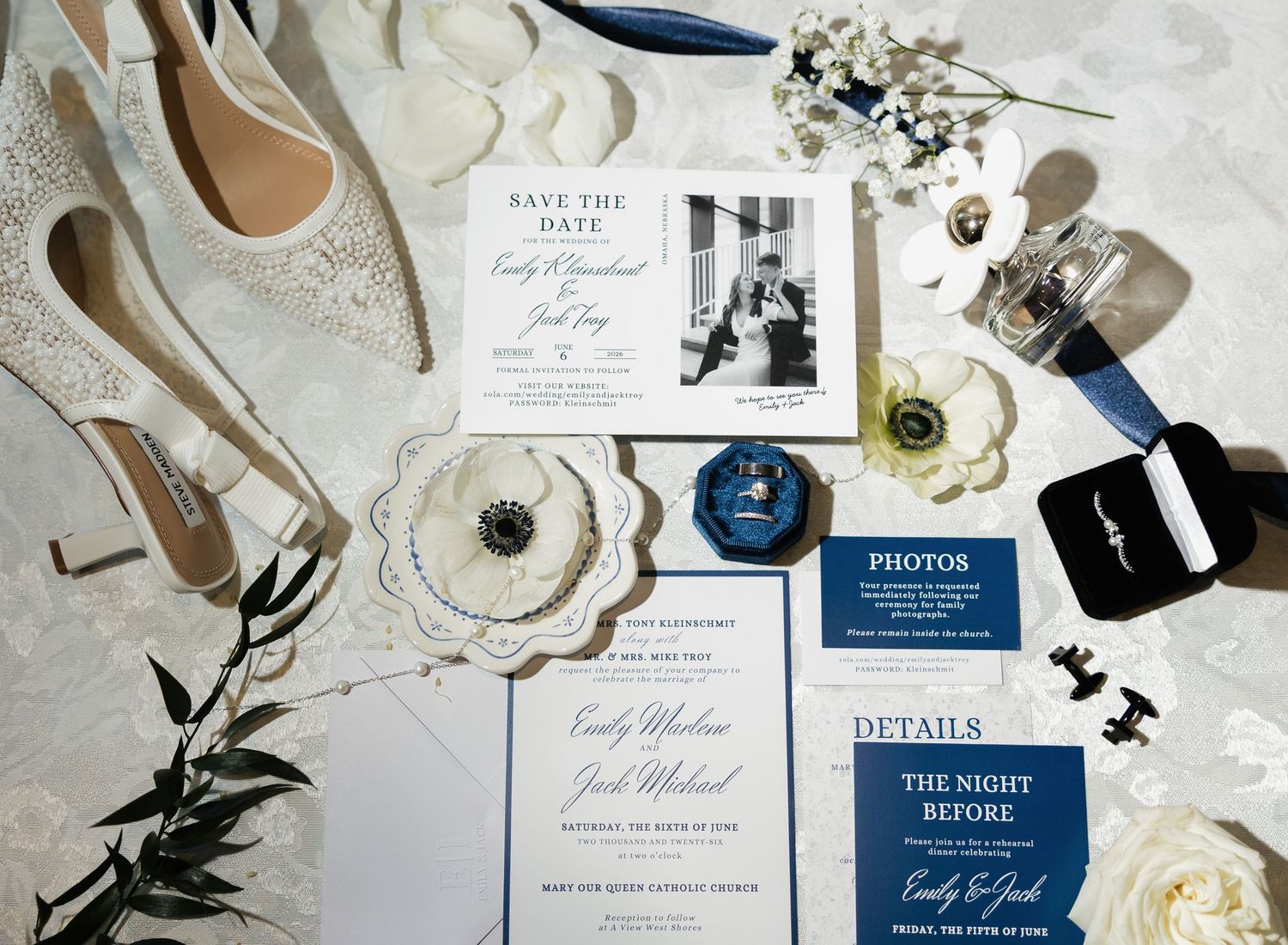Elegant navy and white wedding stationery suite with save the date cards, details cards, and bridal accessories flatlay.