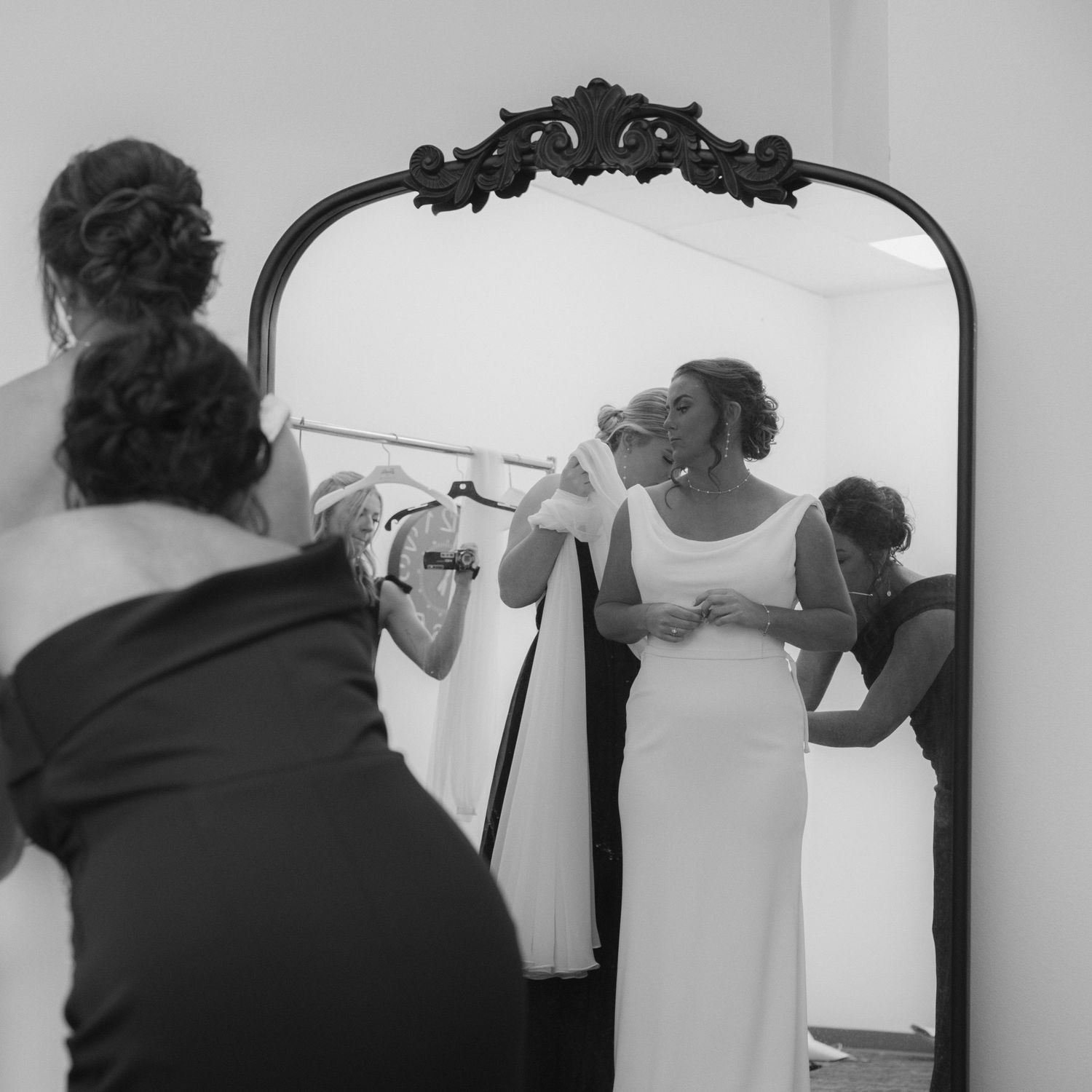 Black and white photo series showing someone drawing a self-portrait in multiple sequential steps on a wall.