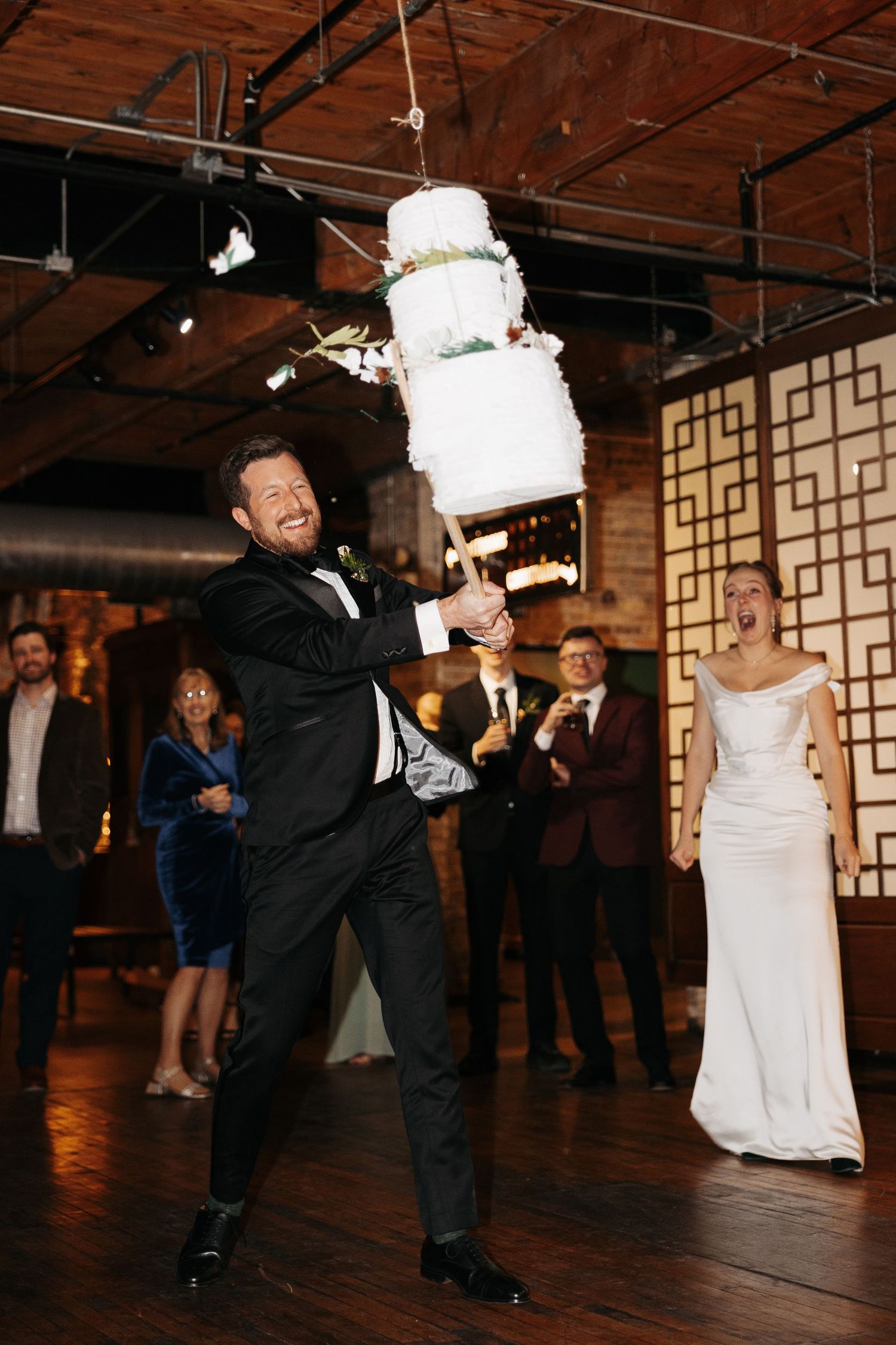 A sequence of dance moves at a wedding reception shows the couple dipping and spinning on a wooden dance floor.