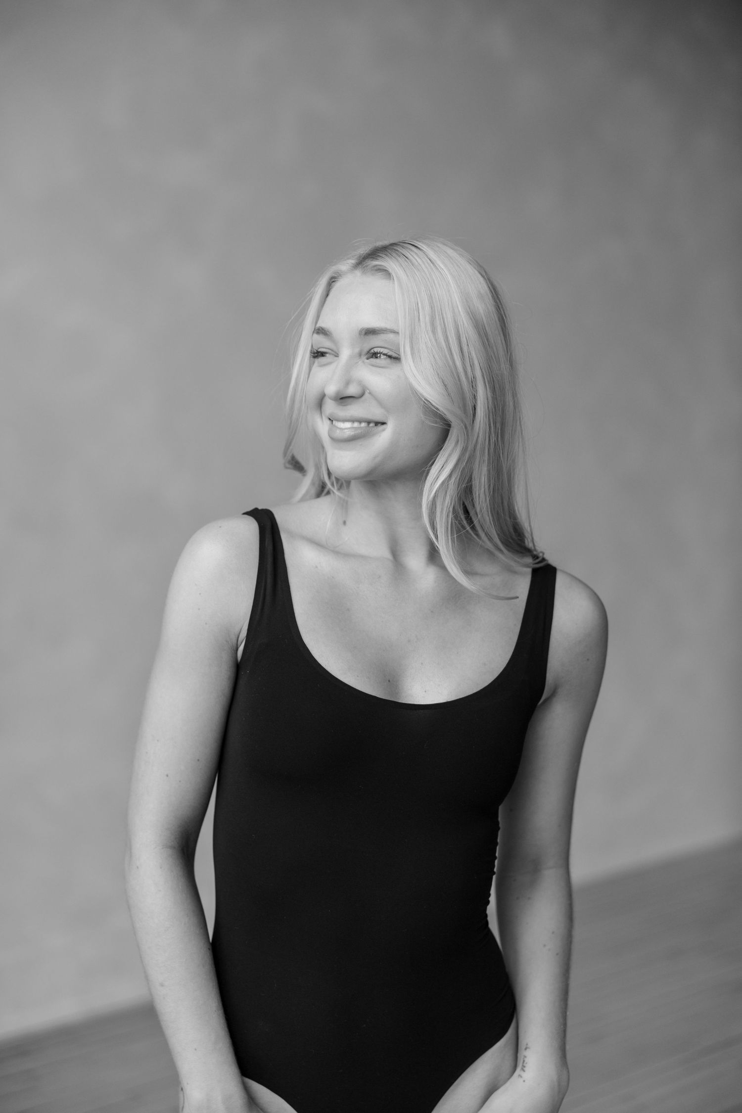 Black and white artistic portrait series showing expressions of joy and laughter against a simple background.