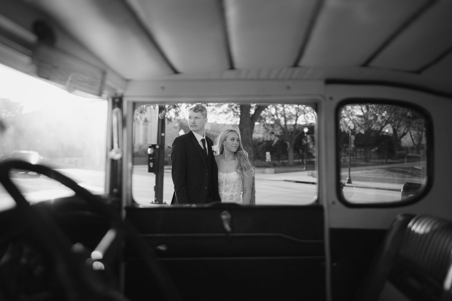 View through vintage car windows at a wedding celebration.
