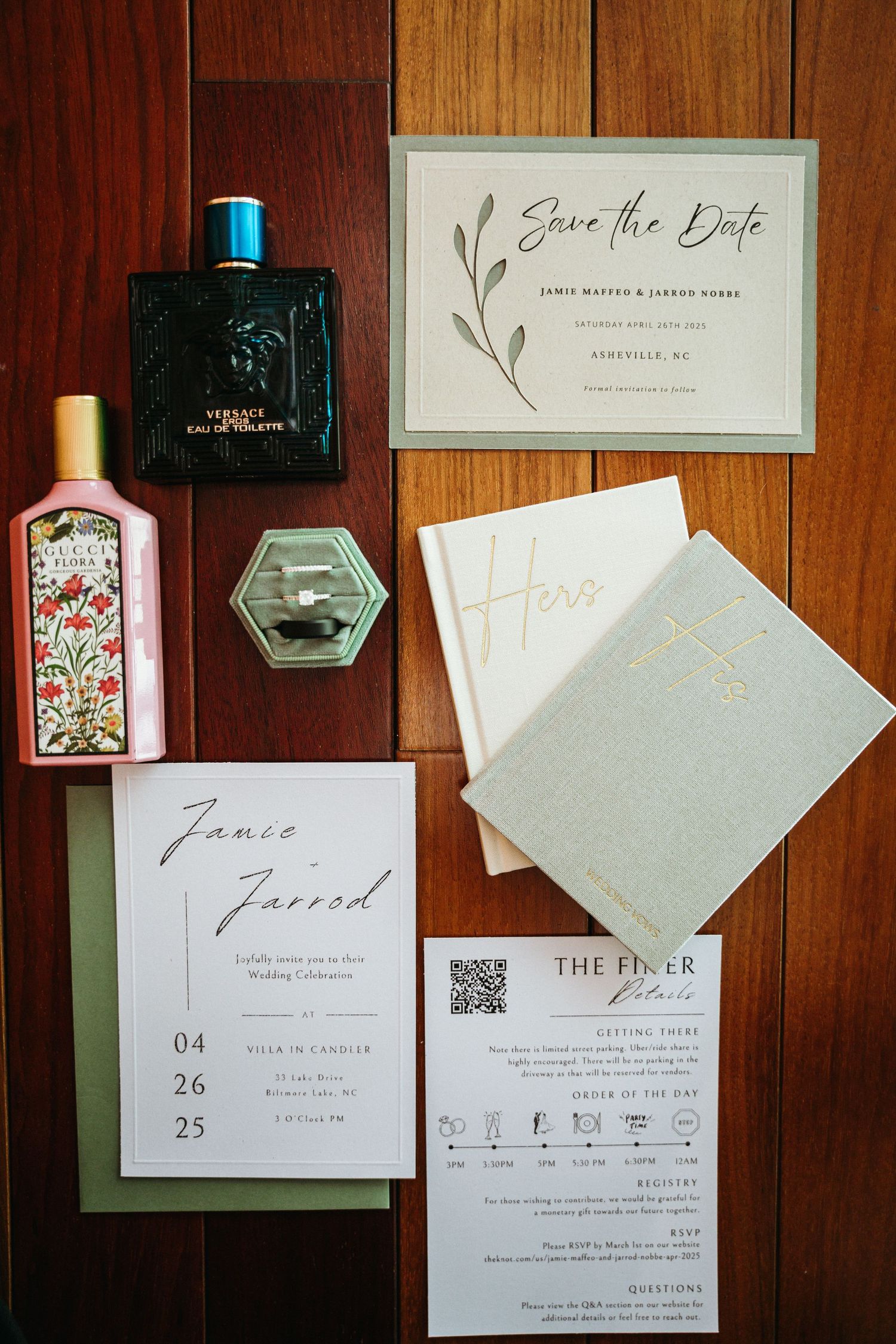 Wedding flat lay featuring save the date cards, perfume bottles, rings, and elegant stationery suite on wood surface.