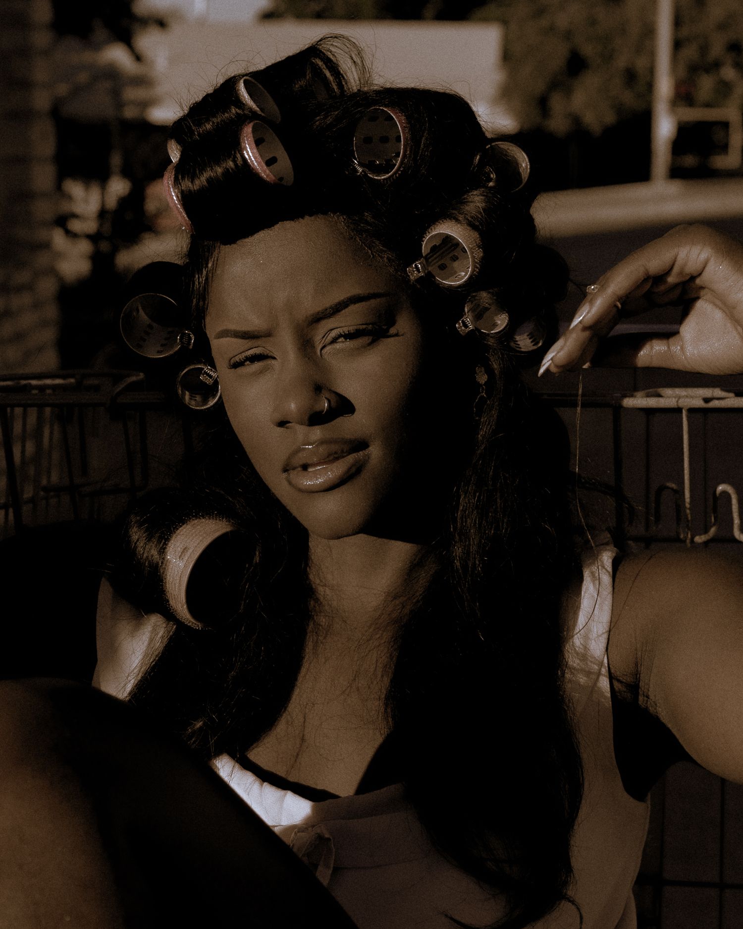 Artistic portrait series showing preparation and styling in sepia tones.
