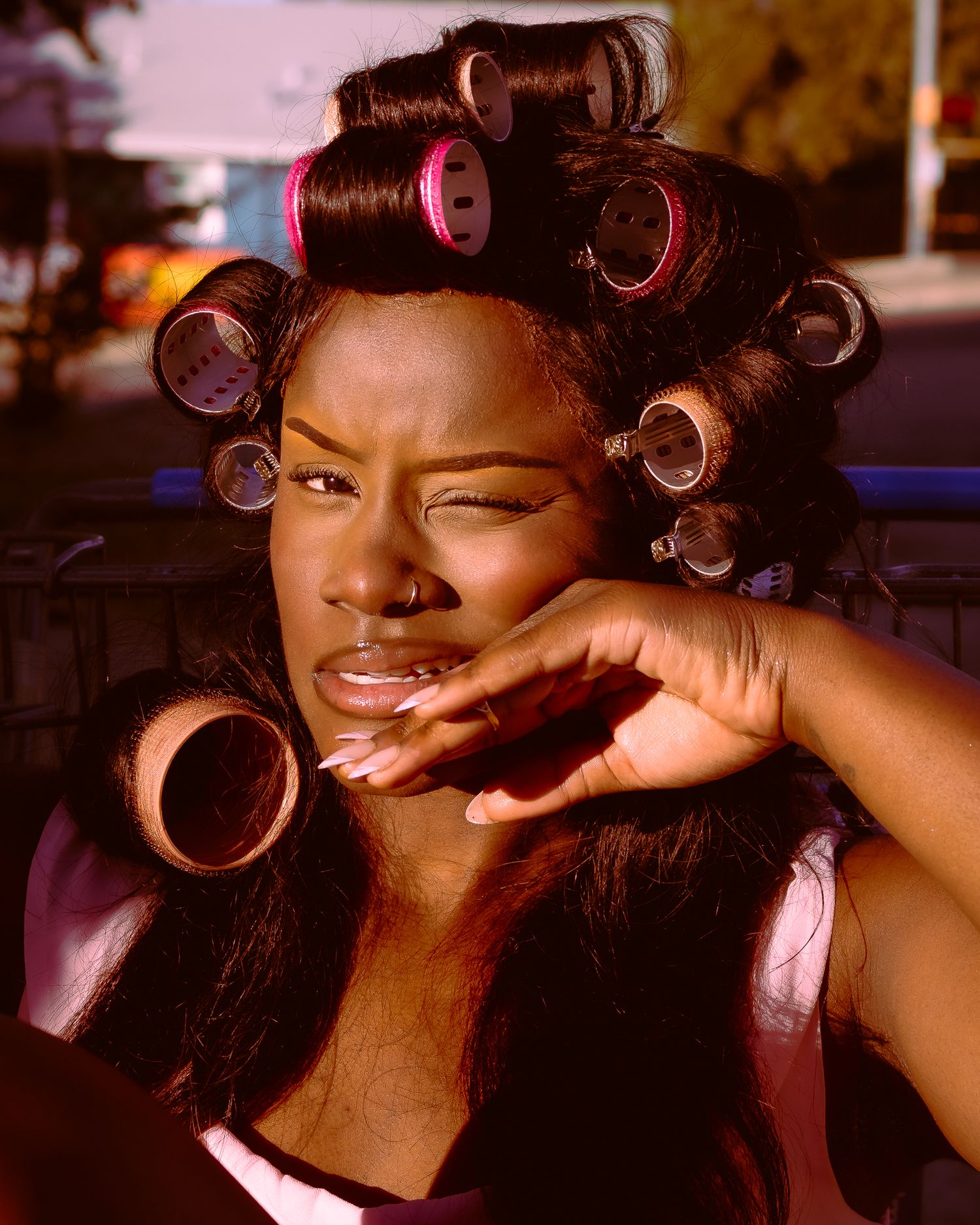 Warm-toned beauty sequence capturing natural expressions and hair styling process.