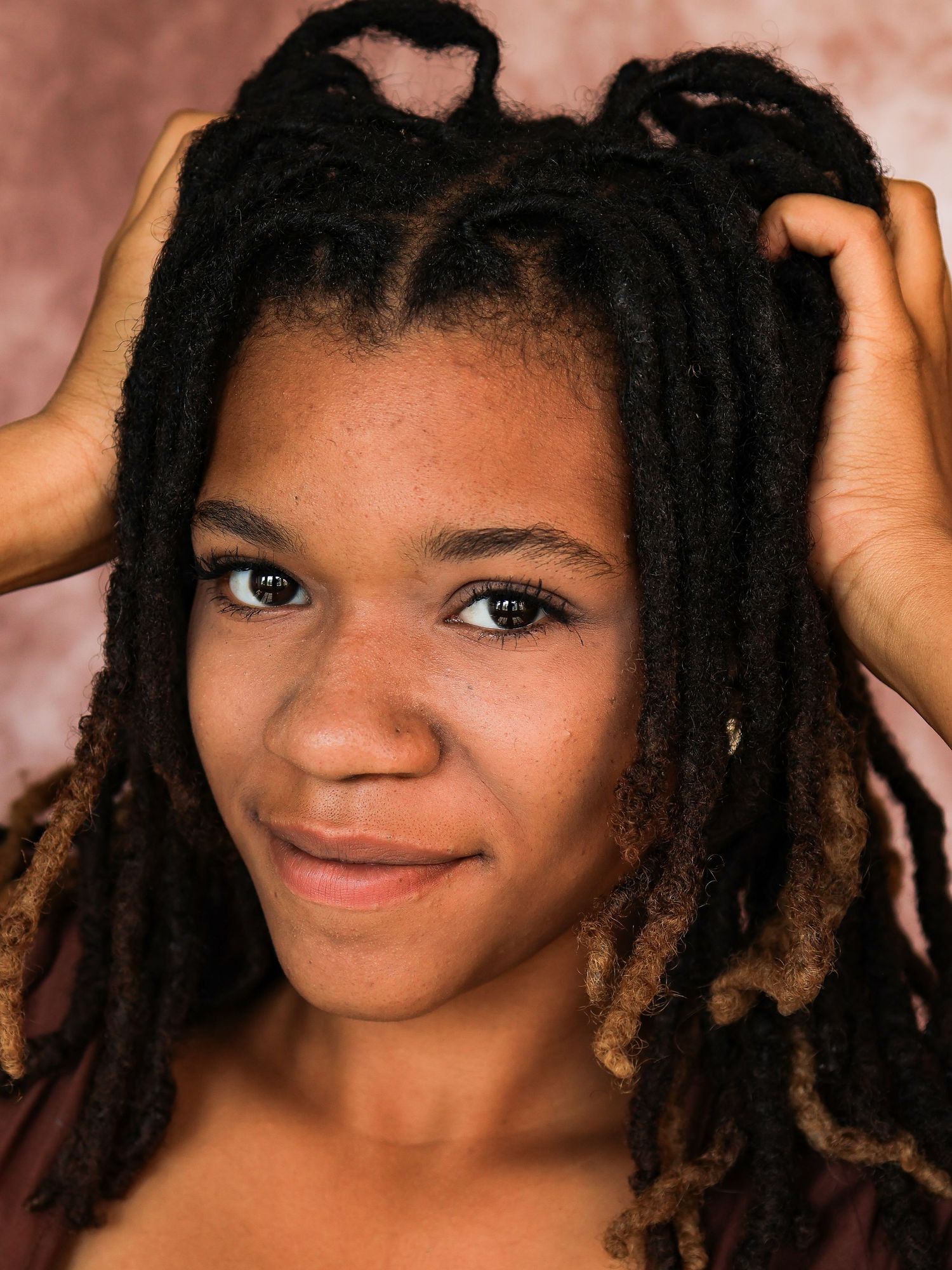 Artistic portrait sequence showing natural hair and genuine expressions against warm brown background.