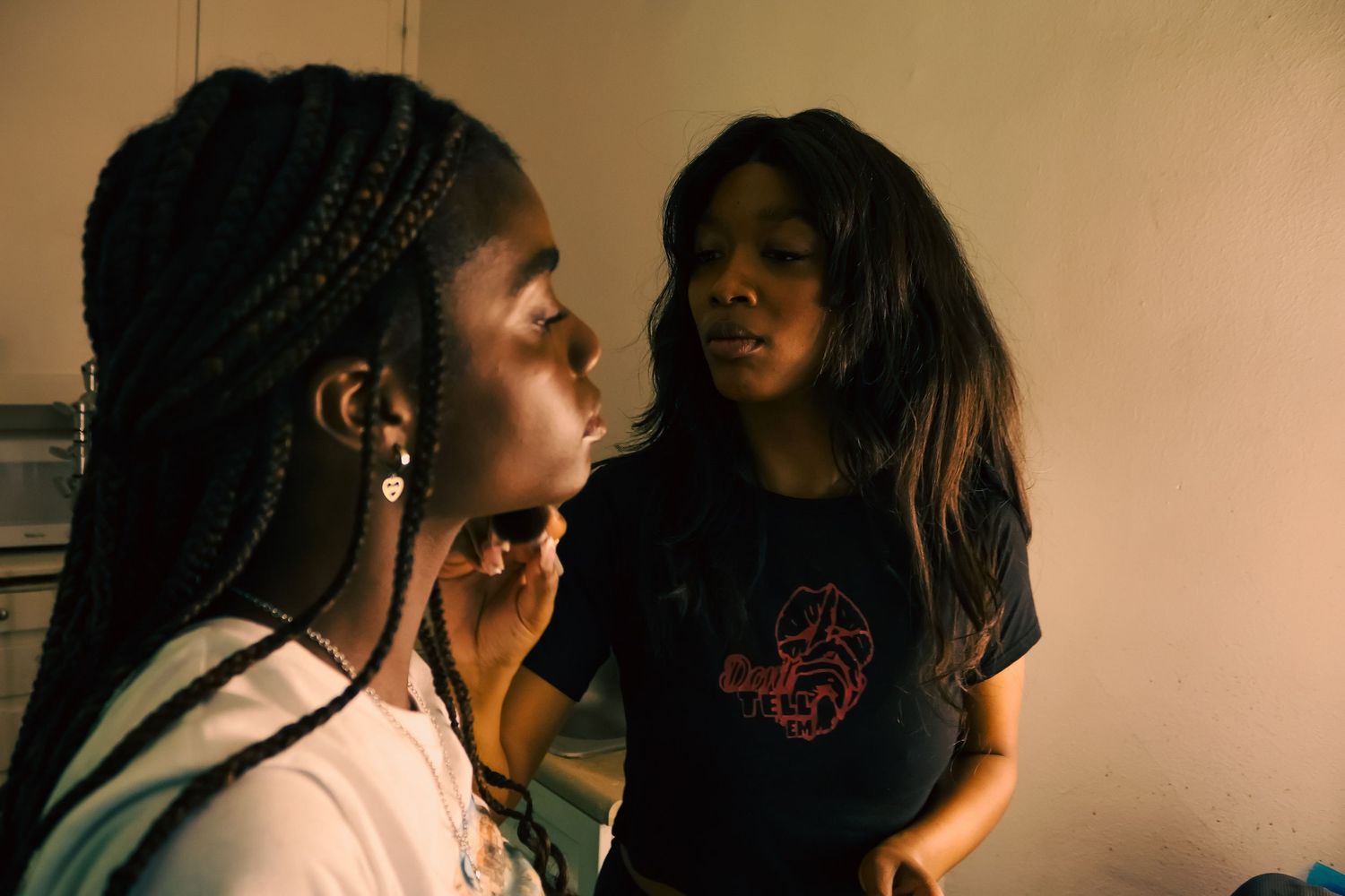 Group interaction scene filmed in dim lighting with casual attire.