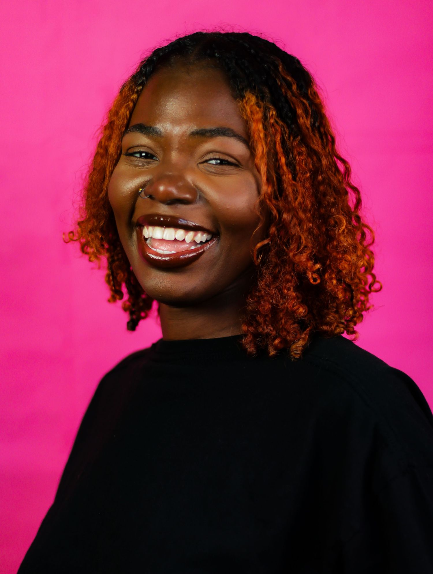 Portrait series showing joyful expressions against vibrant pink background.