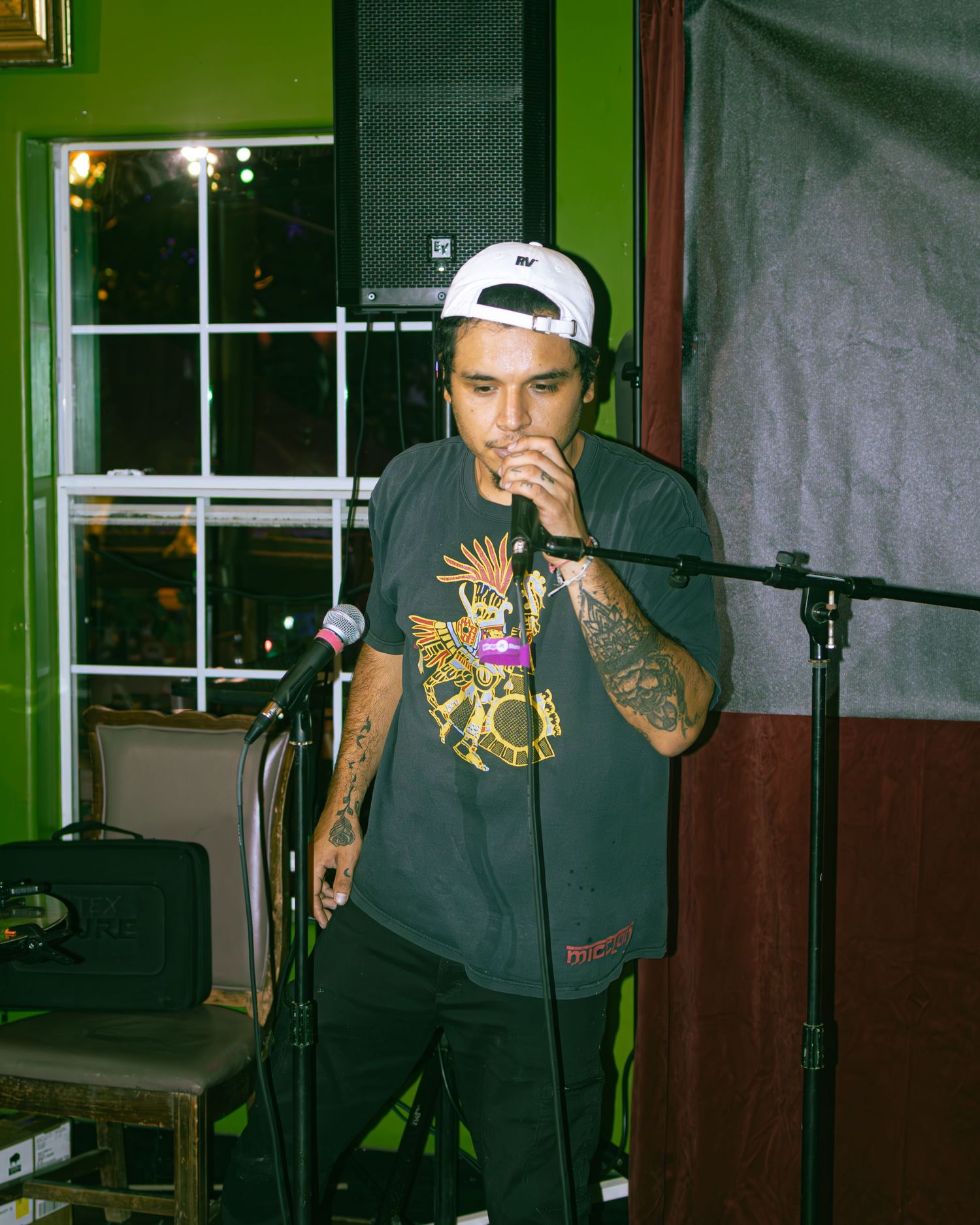 Live performance at intimate venue with green walls and stage lighting.