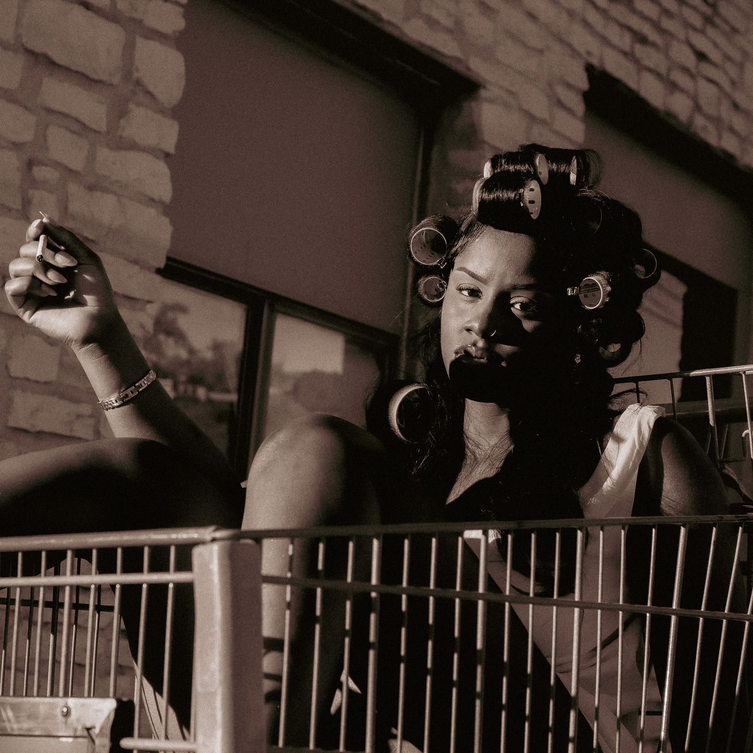 Vintage sepia-toned portrait series showing dramatic lighting and shadows against a brick wall.