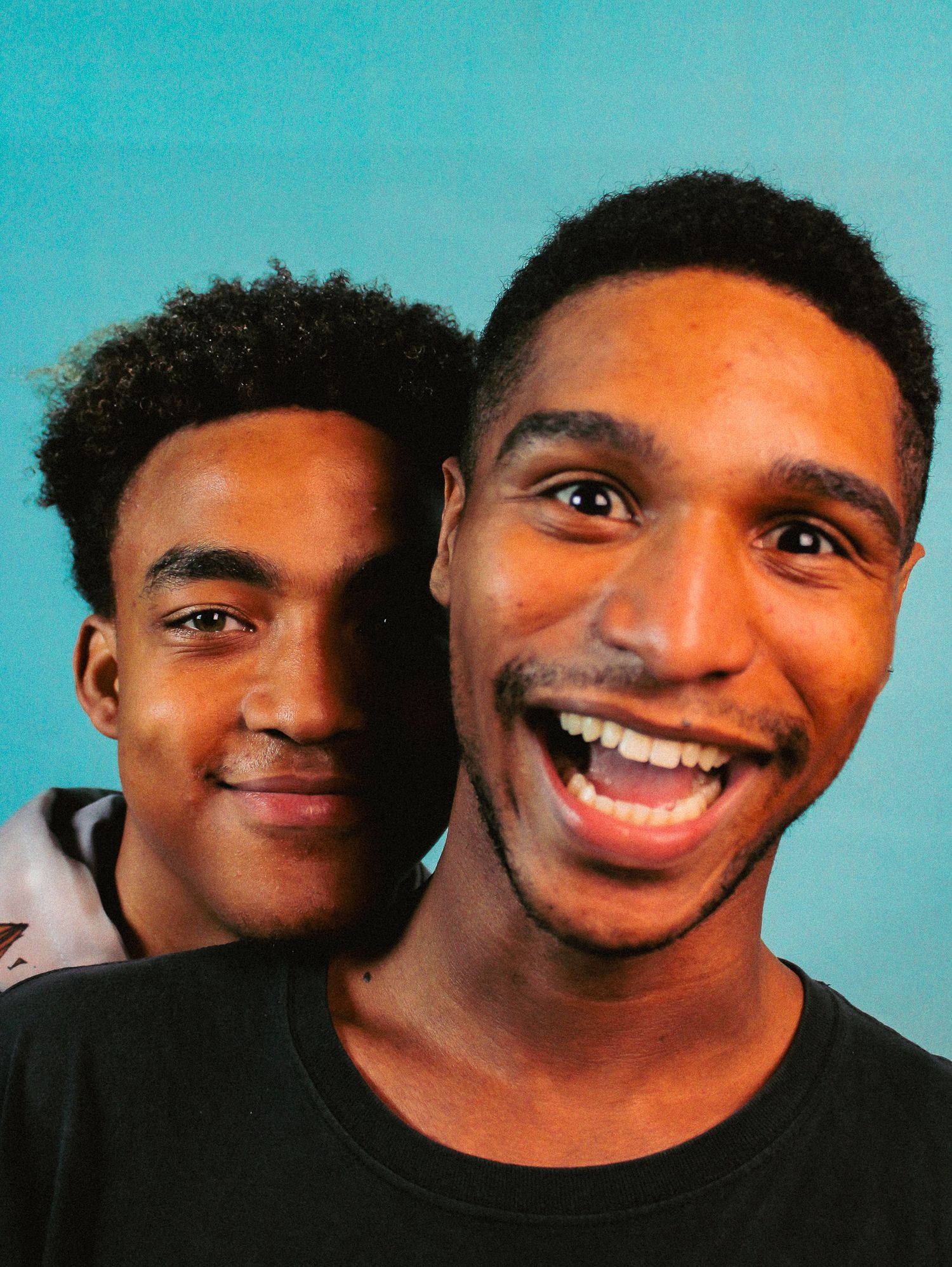 Series of expressive shots against blue background showing genuine joy and laughter.