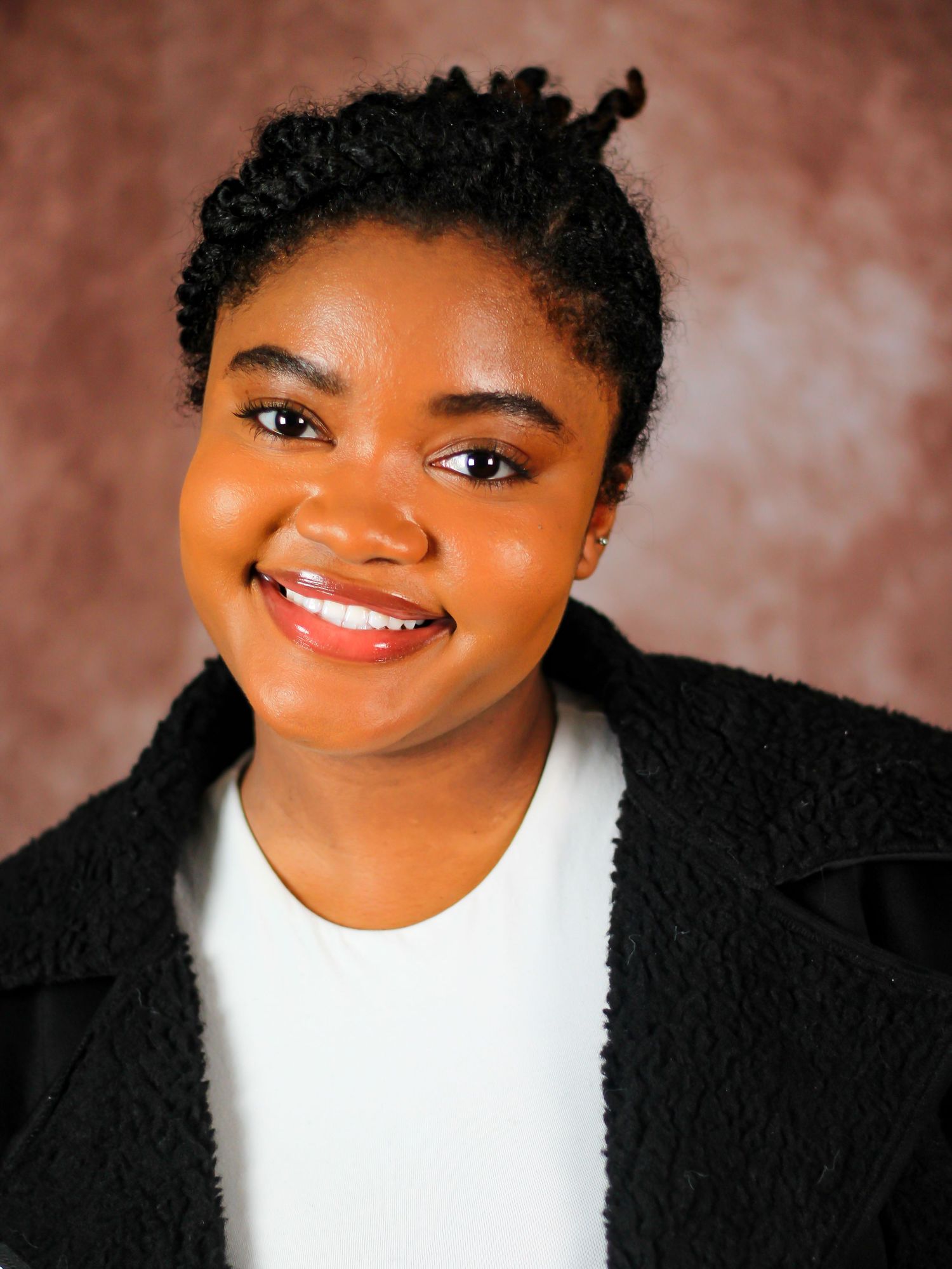 Professional headshots showing bright expressions against a brown backdrop wearing black and white attire.