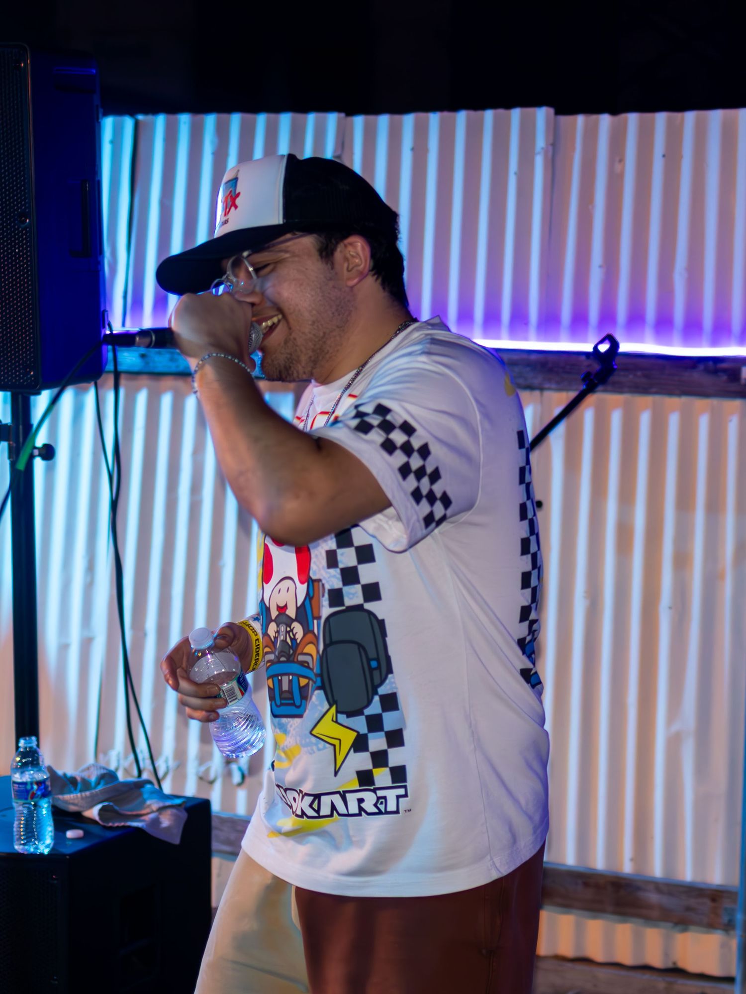 Concert performers in Nintendo-themed attire on stage with checkered patterns.