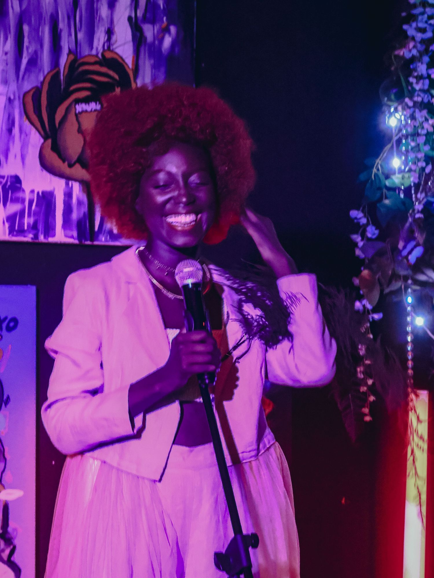An energetic performance on stage with purple and red lighting effects.