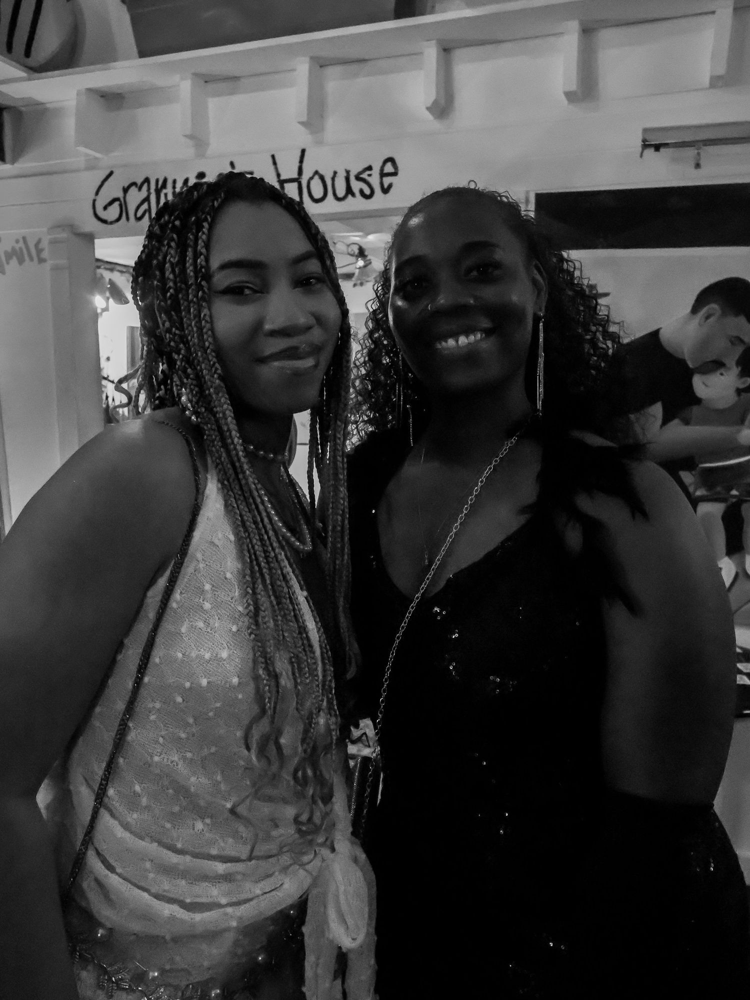 Two people smiling and posing together at an indoor party venue.