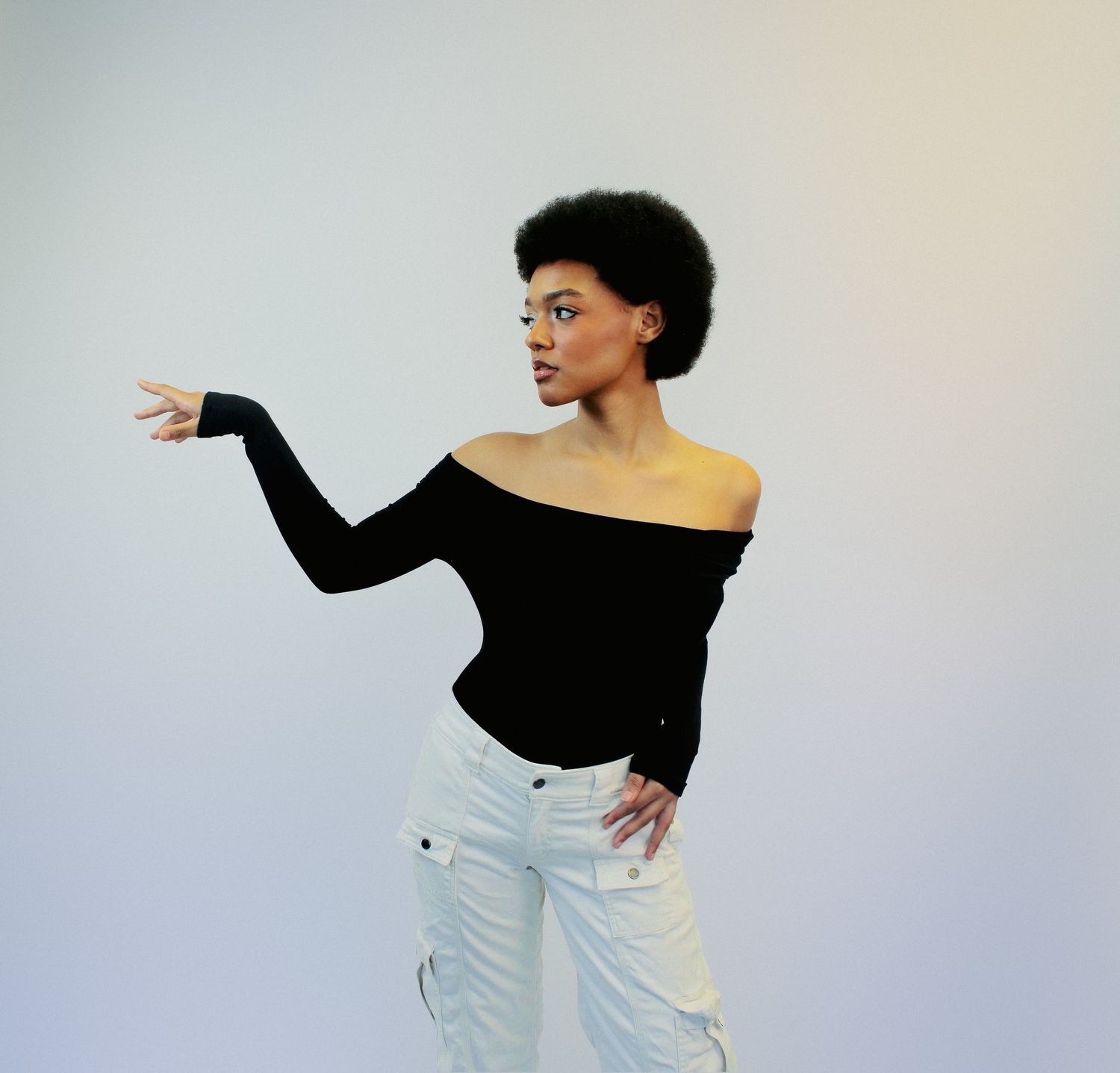 Person in off-shoulder black top and white pants striking artistic poses against neutral background.