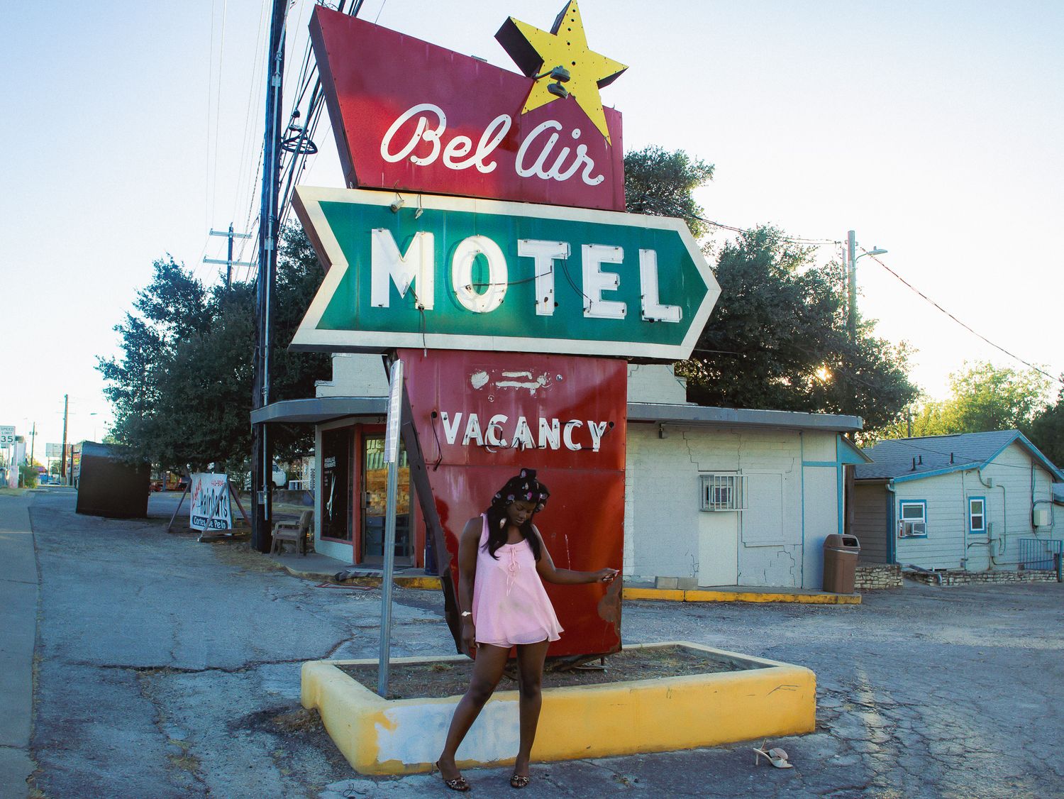 Nostalgic motel sign with yellow star against blue sky at sunset.