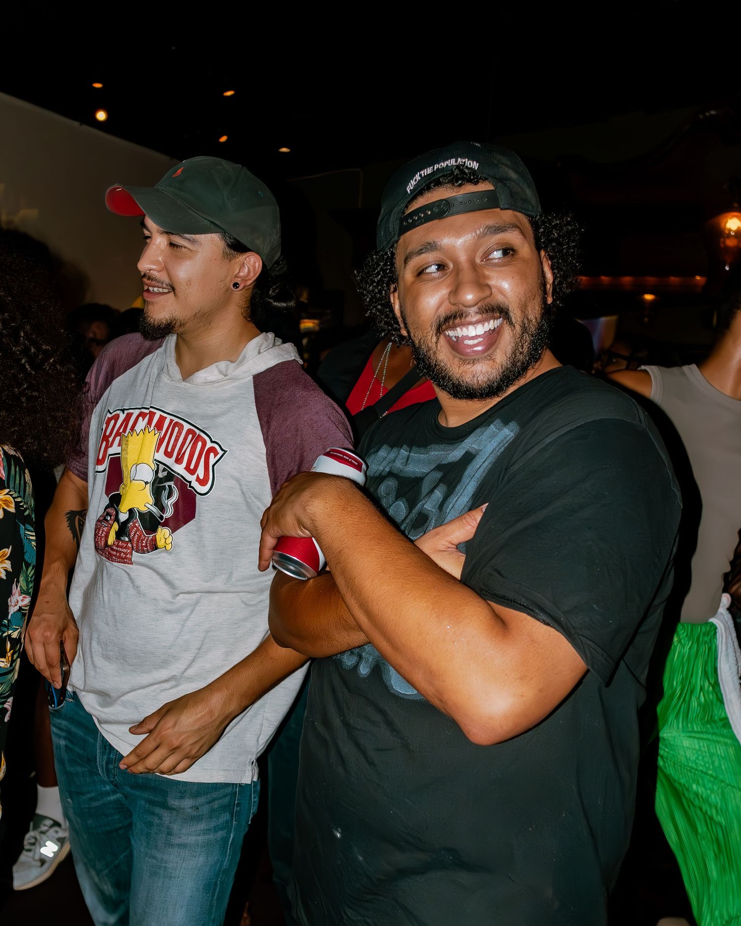 Energetic crowd scene at indoor music venue with performers and audience members interacting.