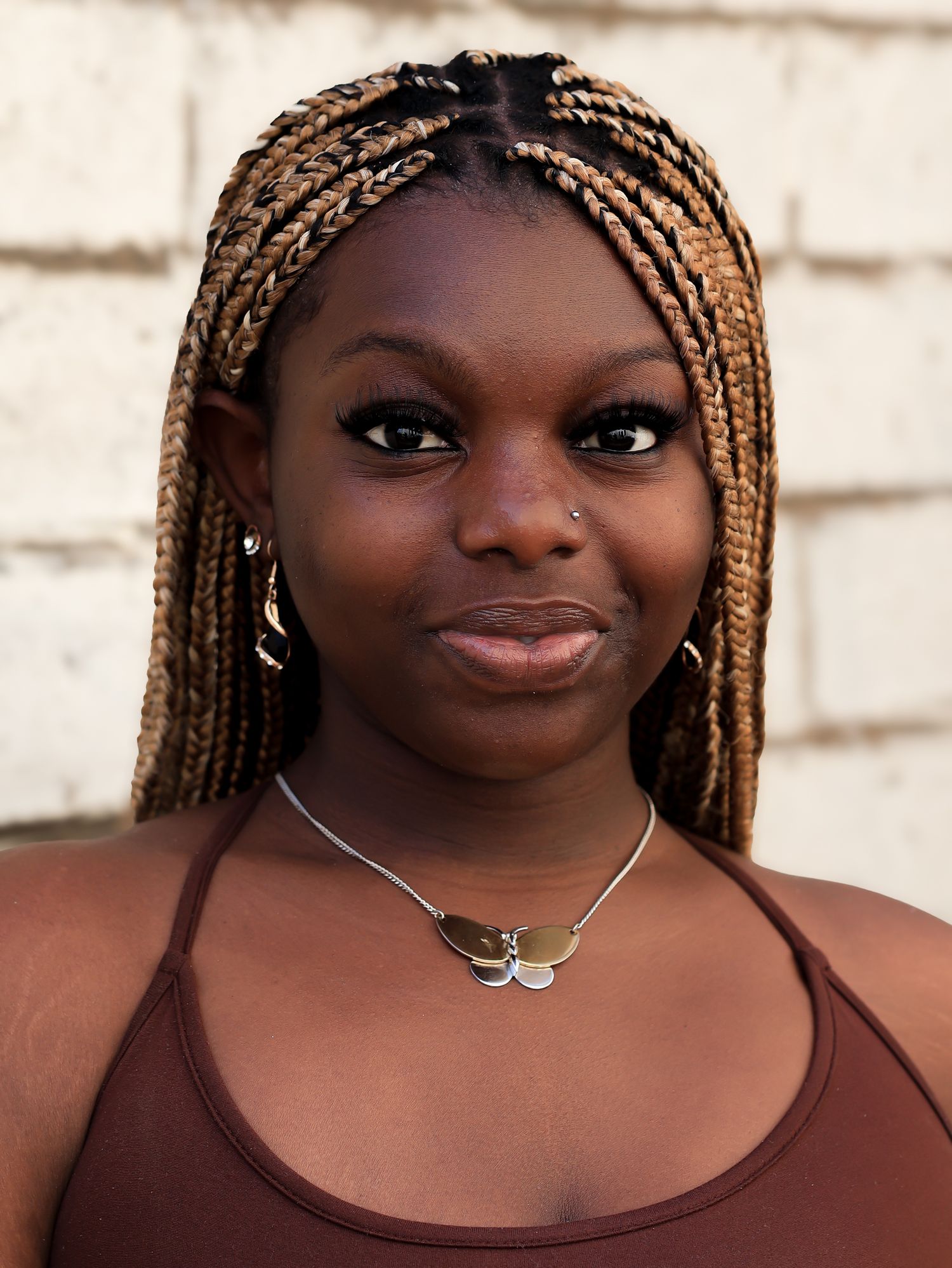 Close-up portrait sequence showing braided hair and jewelry against a light background.