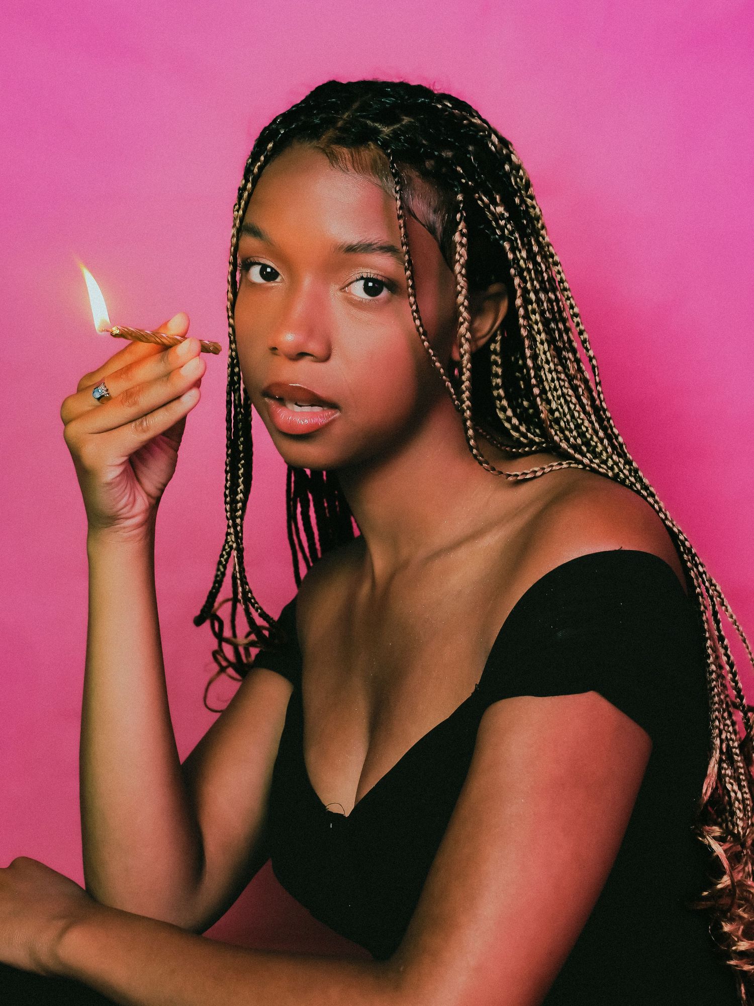 Artistic portraits with braided hair showing dynamic poses against pink backdrop.