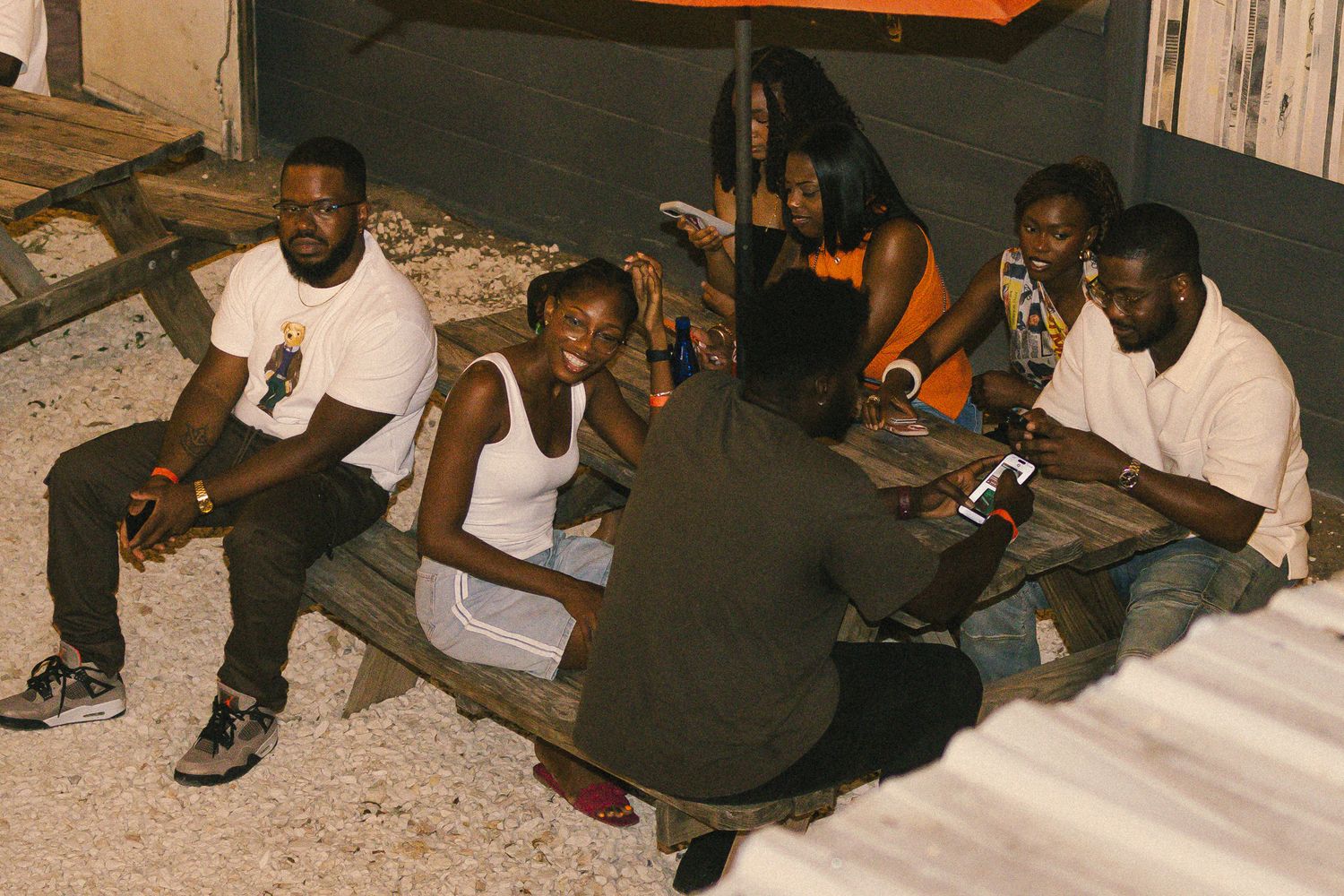 Friends sitting in a circle during a casual outdoor gathering.