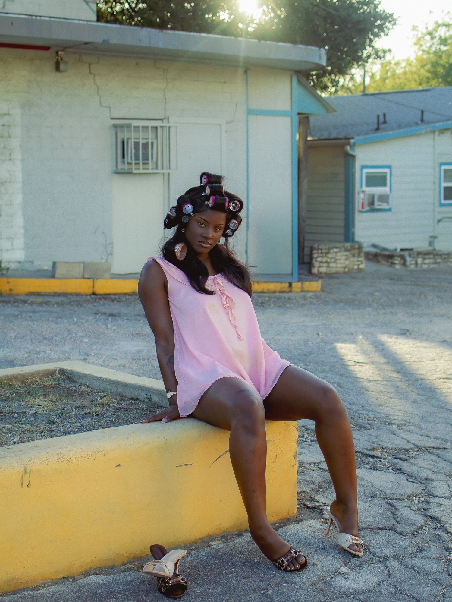 Outdoor portrait session on a yellow concrete bench with retro styling elements.