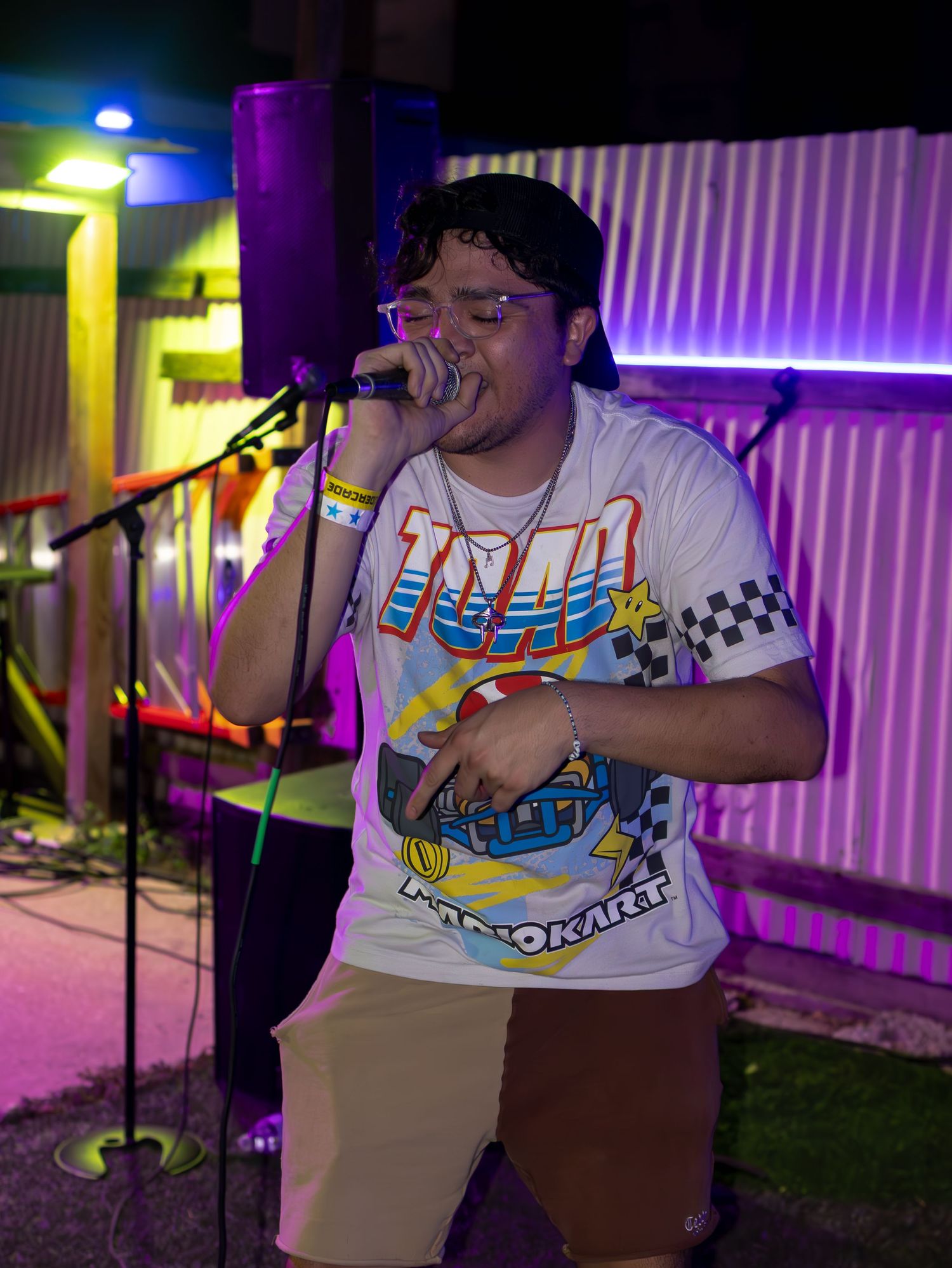 Stage performance with colorful lighting and gaming-themed attire visible.
