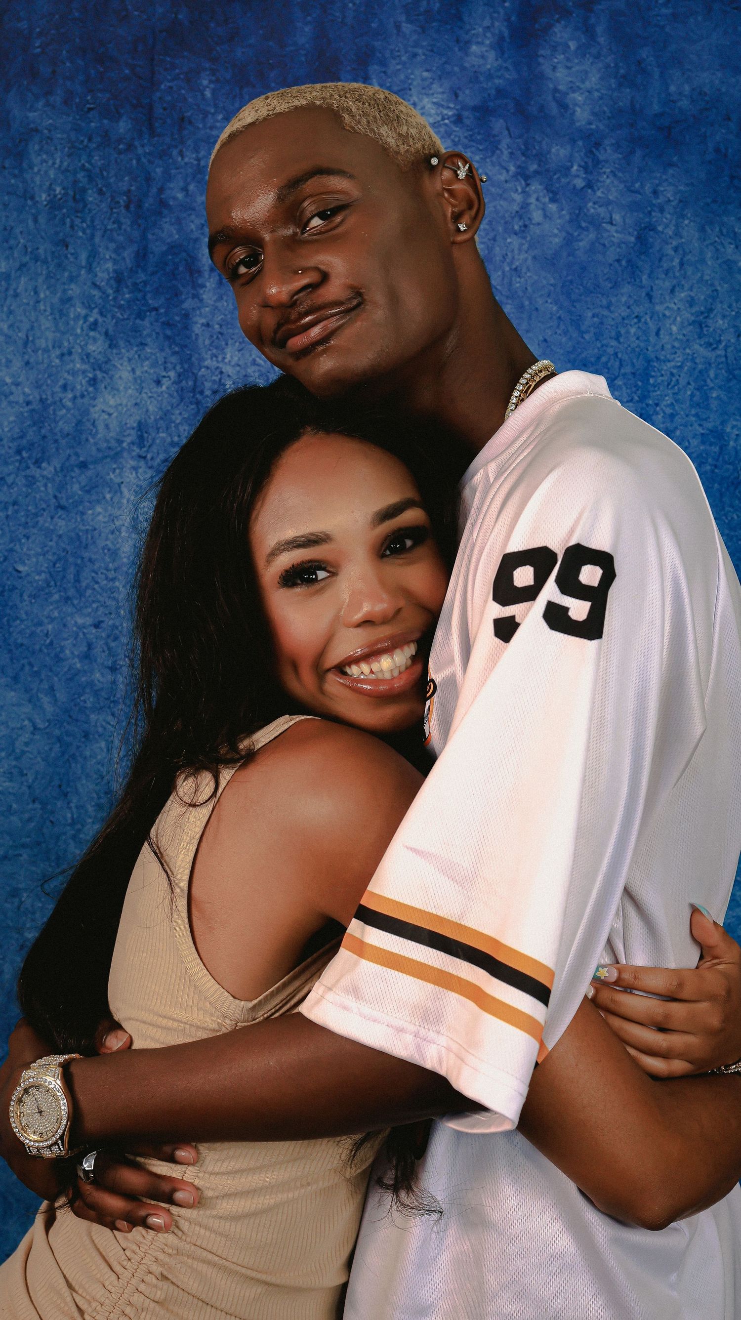 A couple shares joyful laughter during their portrait session.